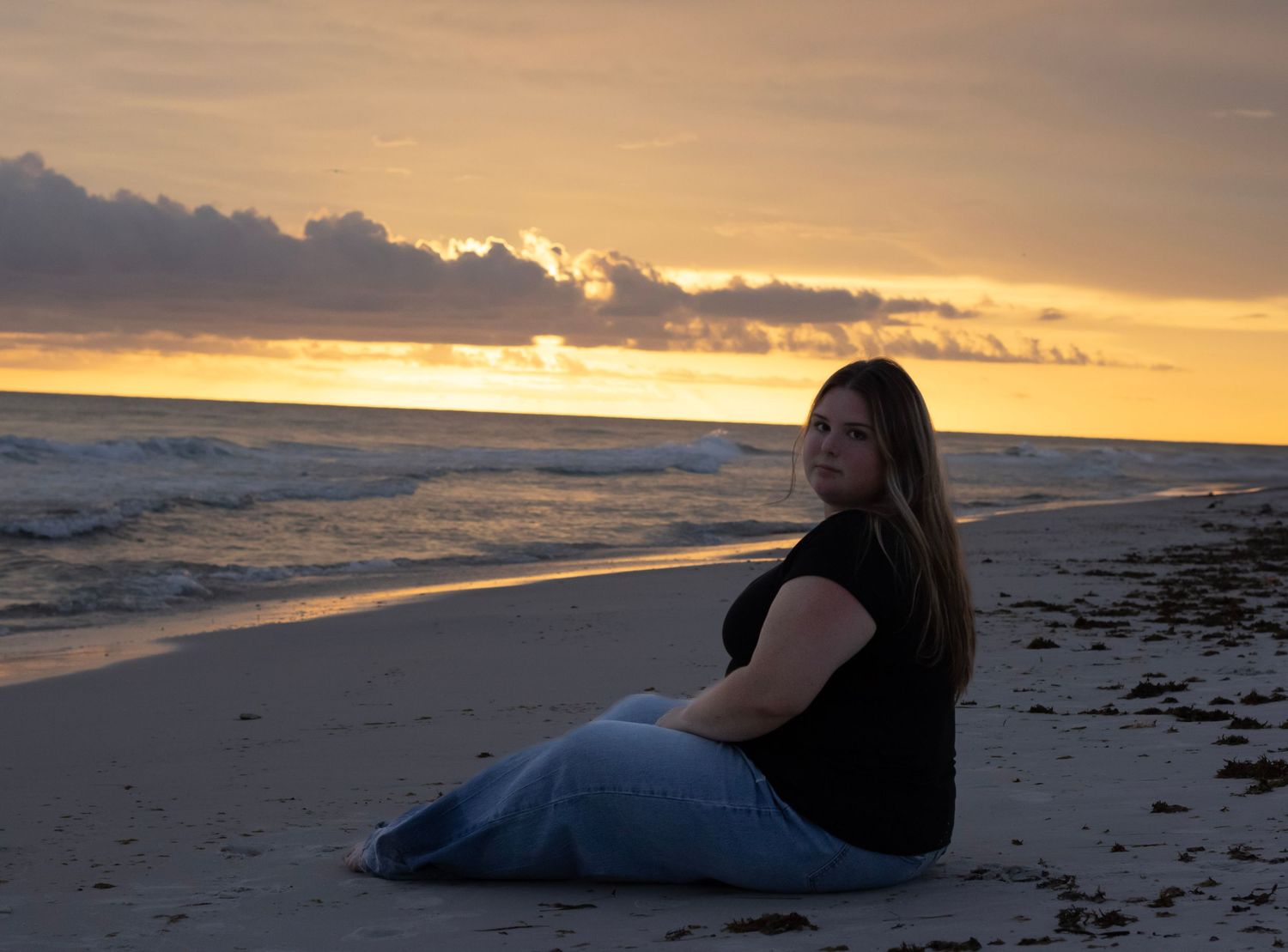 This photo shows a beautiful sunset on a beach, and my model is placed to be the center of attention.