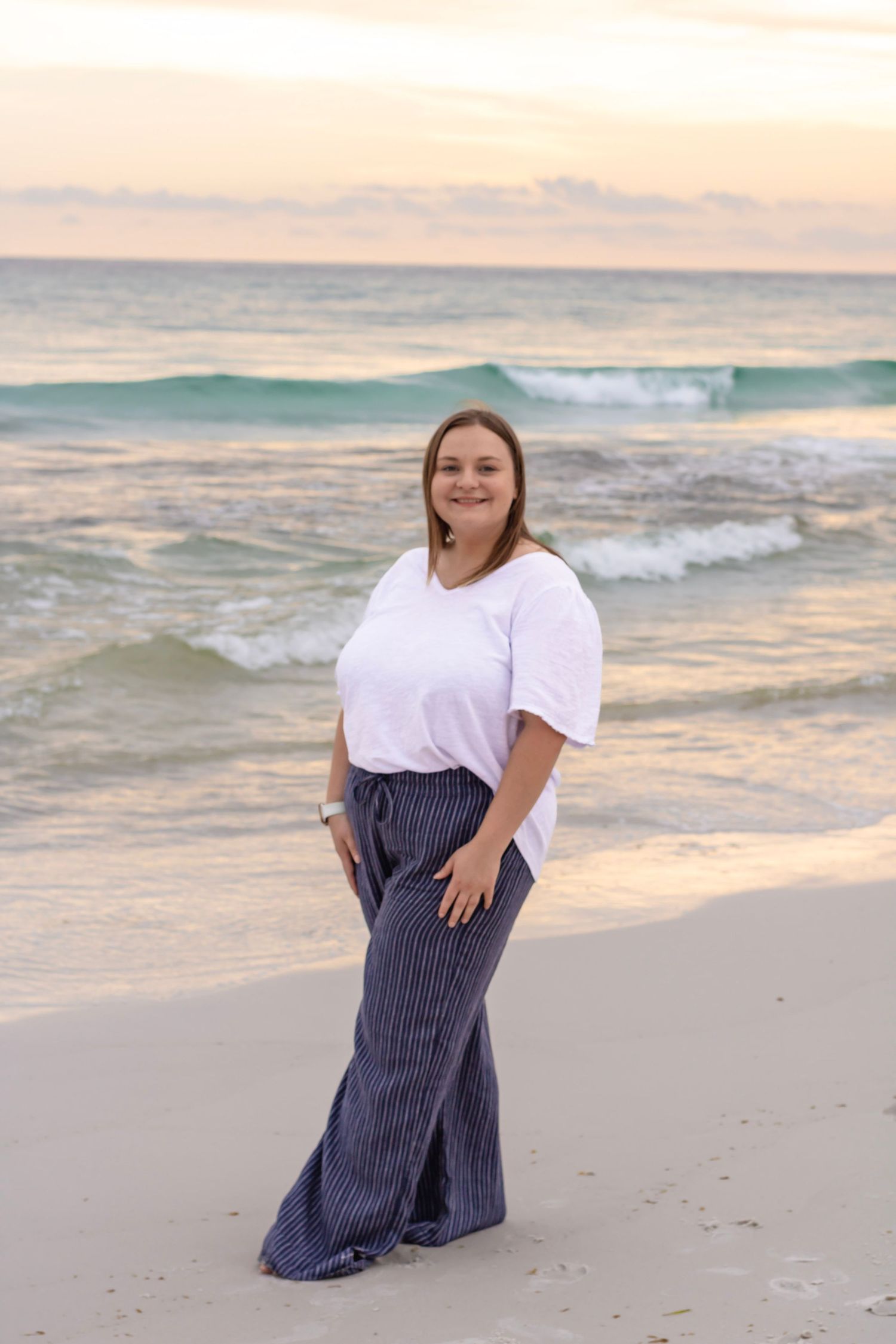 This is a portrait on the beach with pastel colors giving the model all of the attention