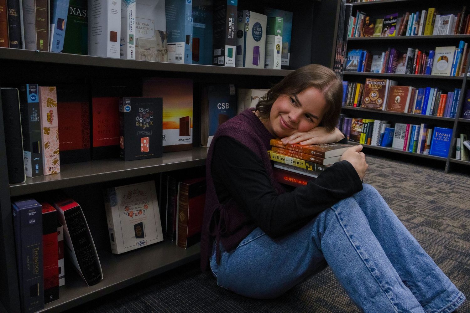 A picture in the bookstore. She is sitting on the ground with her head on a stack of books. If you're a book reader, you'll love this photo!
