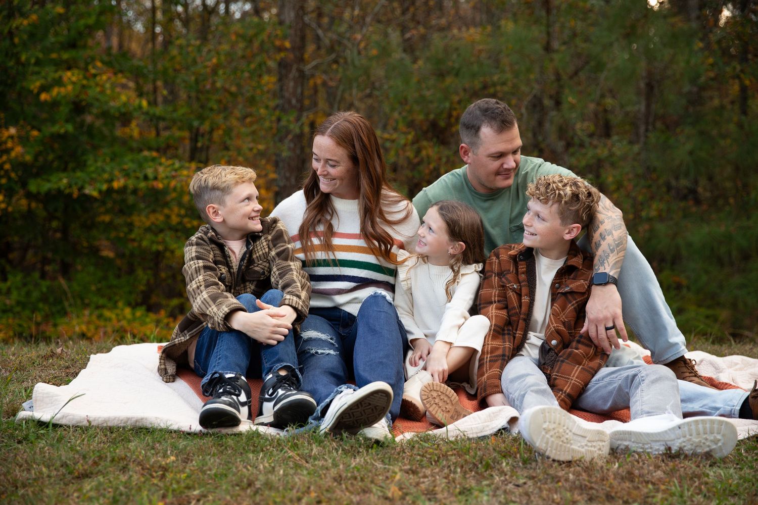 Family sitting together on blanket outdoors during autumn photoshoot-Northwest Georgia Jessica M Cooper Photography LLC