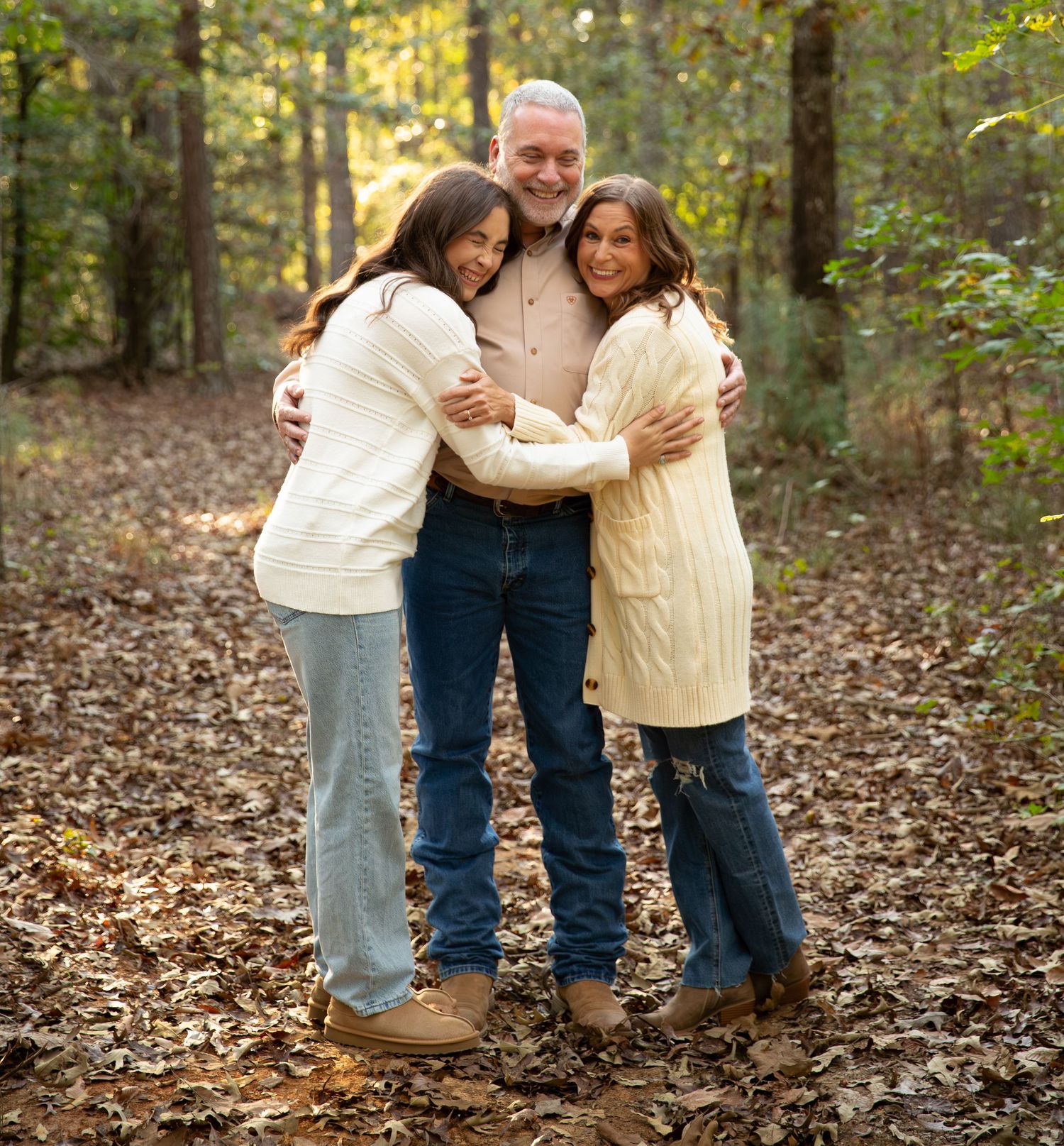 Warm family embrace in autumn forest setting with fallen leaves-Northwest Georgia Jessica M Cooper Photography LLC
