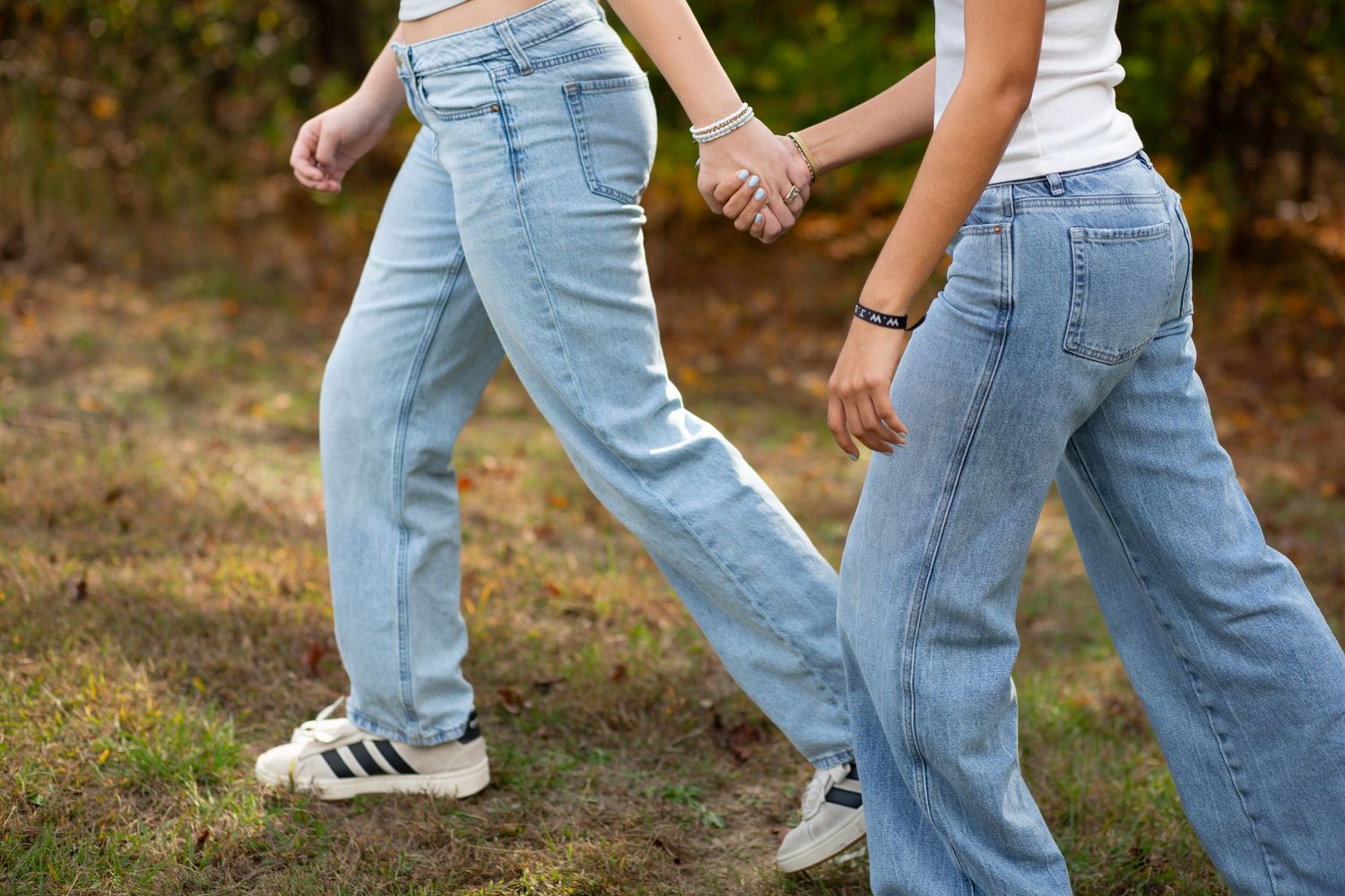 Close-up of legs in blue jeans and sneakers walking together outdoors-Jessica M Cooper Photography LLC Rome GA