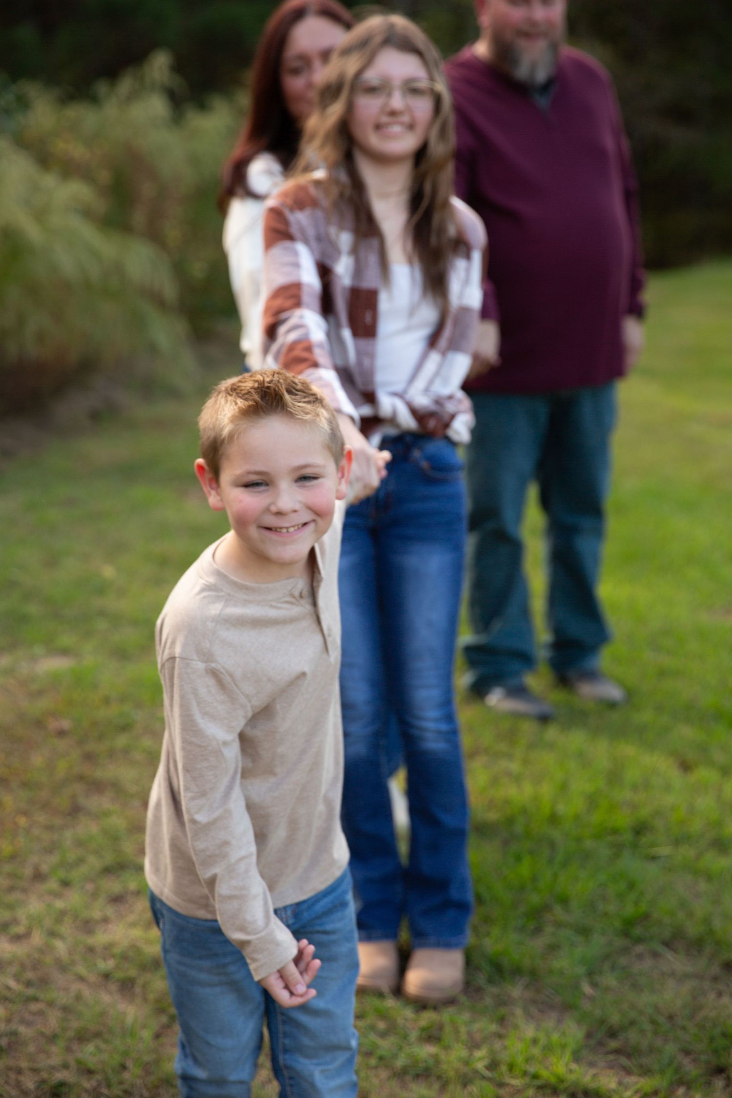 A young child leading family playfully in line- Rome Ga Jessica M Cooper Photography LLC