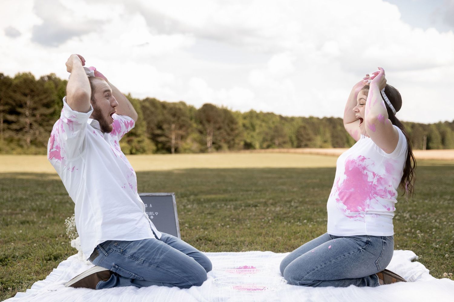 Husband and wife gender reveal using pink paint and blind folds. Berry College, Rome, GA Jessica M Cooper Photography LLC