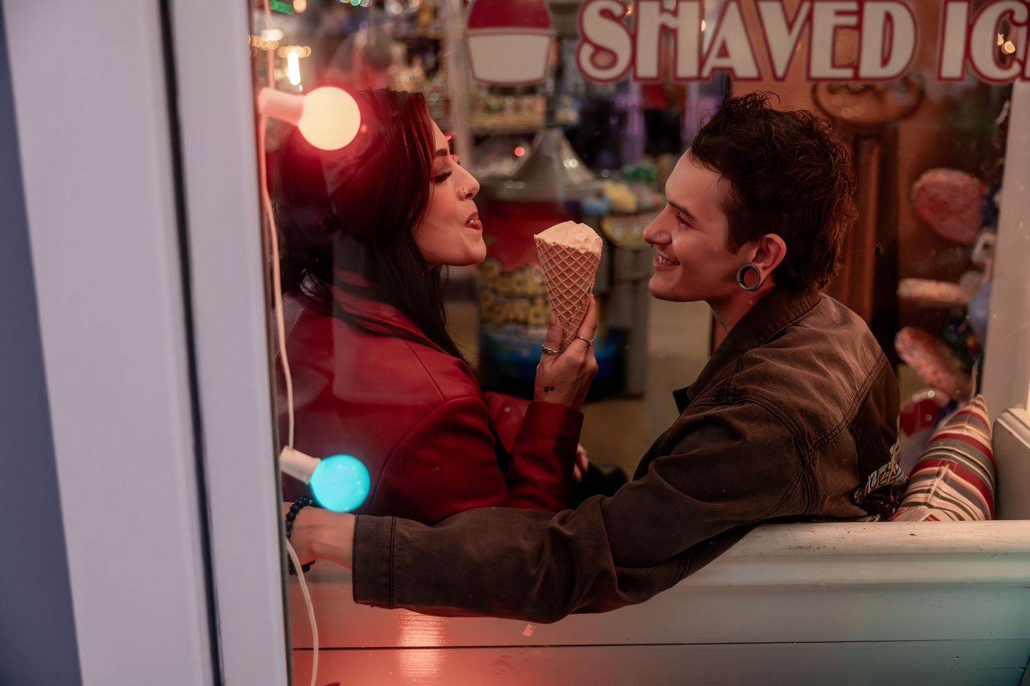 Two people share a joyful moment at a shaved ice stand, smiling at each other through the window. Downtown Rome, GA