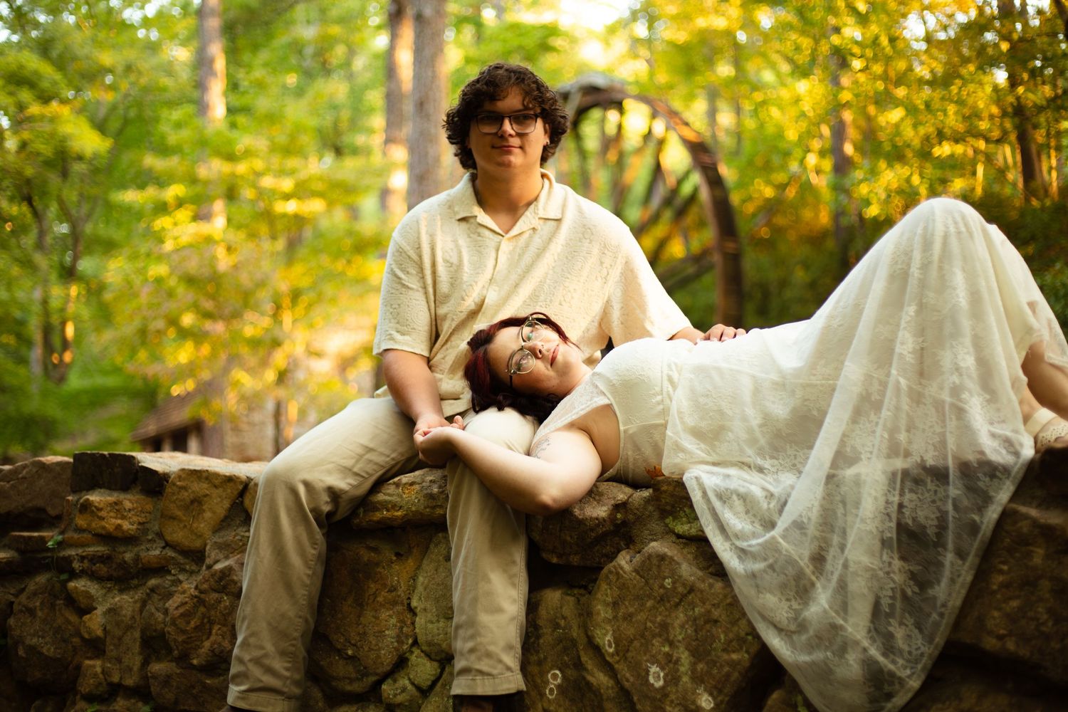 Romantic couple lying in autumn leaves during an outdoor photo session at Berry College-Jessica M Cooper Photography LLC Rome GA
