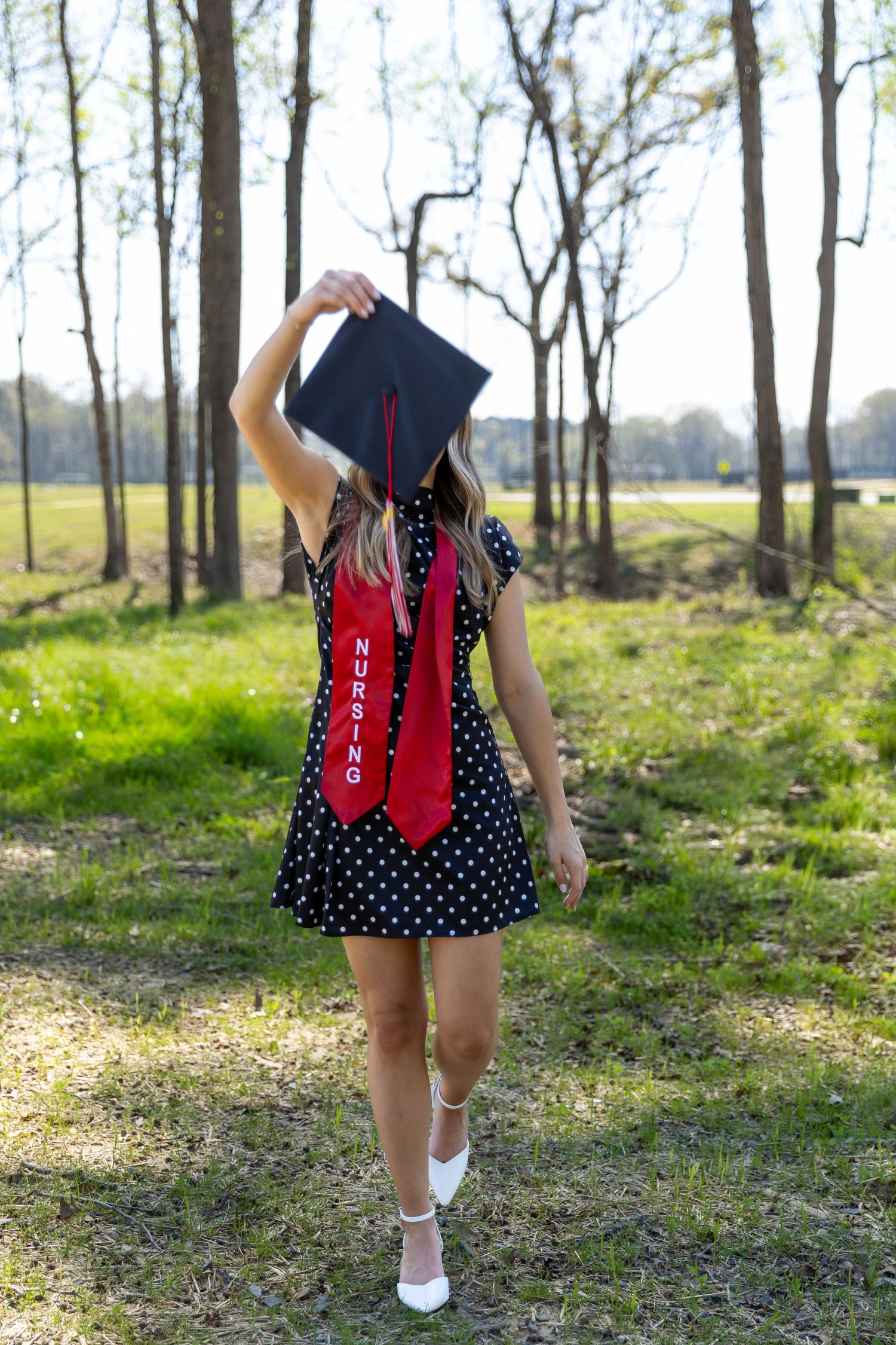 A girl with graduation cap and red nursing stole in  Rome, GA Jessica M Cooper Photography LLC
