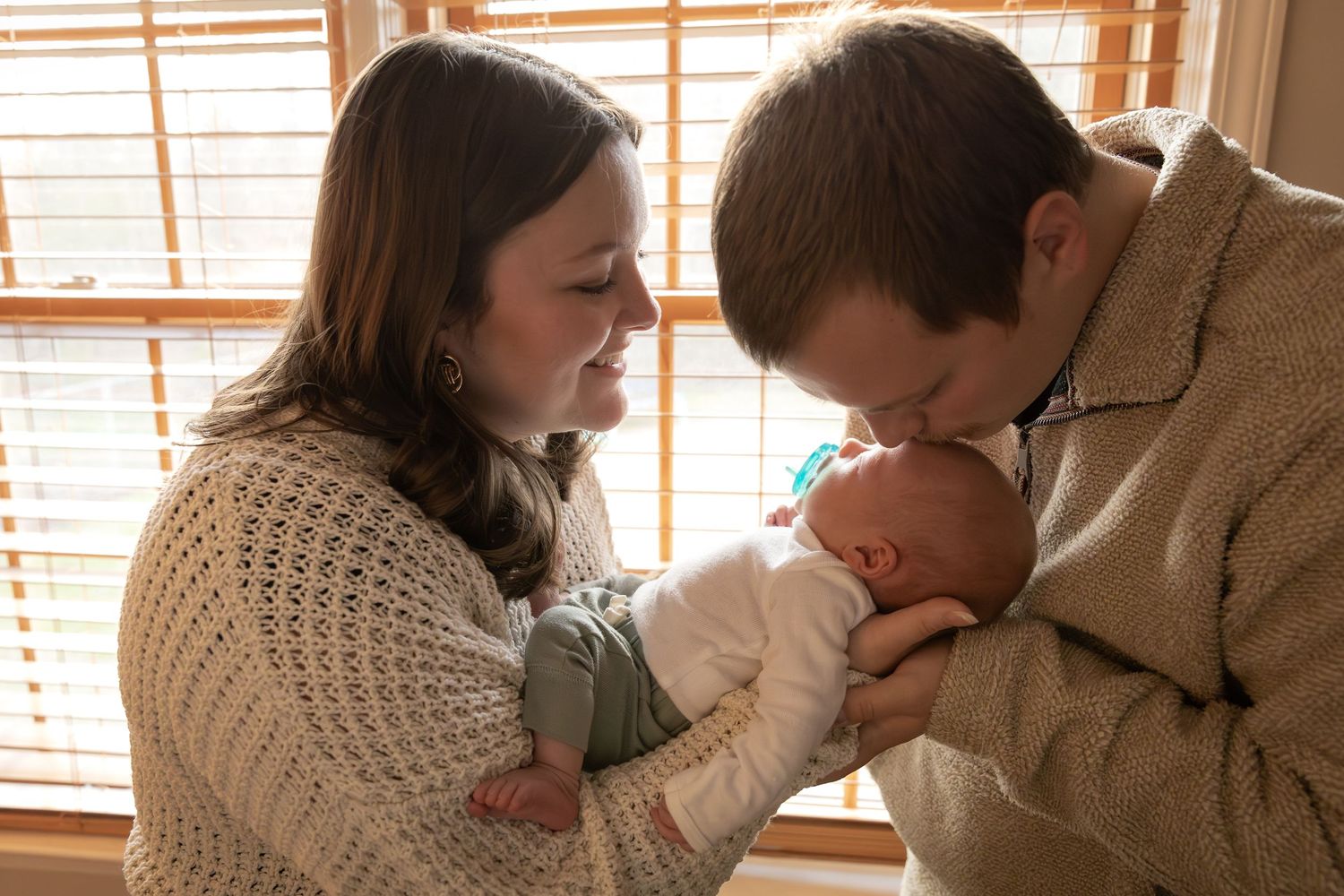 In-home newborn session embrace with parents and baby-  Rome, GA Jessica M Cooper Photography LLC