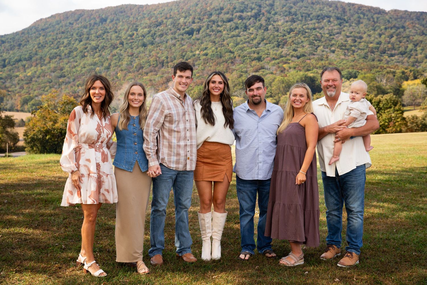 Large family group poses together in coordinated outfits with mountains in the background-Northwest Georgia Jessica M Cooper Photography LLC