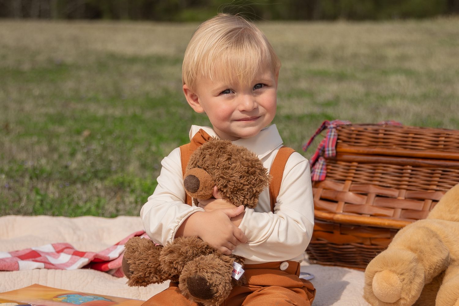 A child sits outdoors with a teddy bear and picnic basket on a sunny day.  Rome, GA Jessica M Cooper Photography LLC