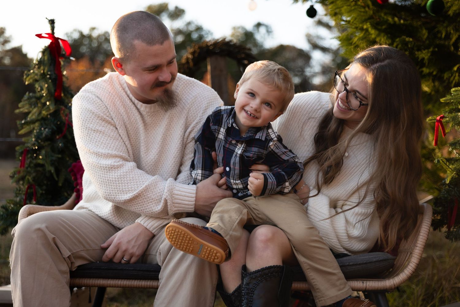 Family sharing joyful moments together during an outdoor Christmas photoshootJessica M Cooper Photography LLC Rome GA