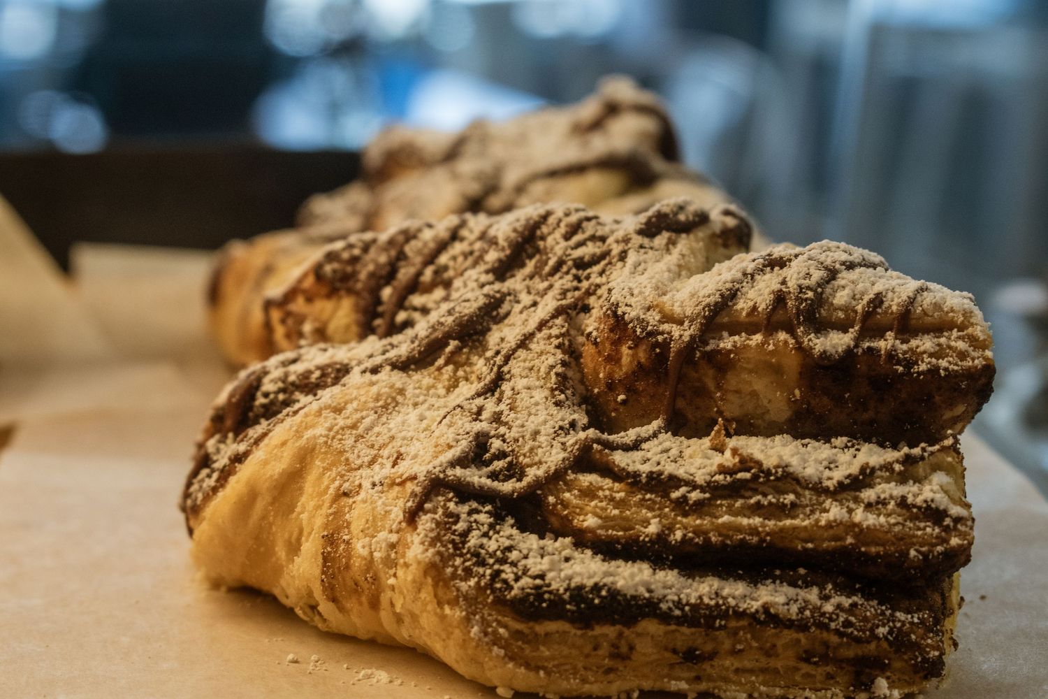 Close-up of a rustic, flour-dusted artisan bread loaf with a textured crust on a wooden surface.