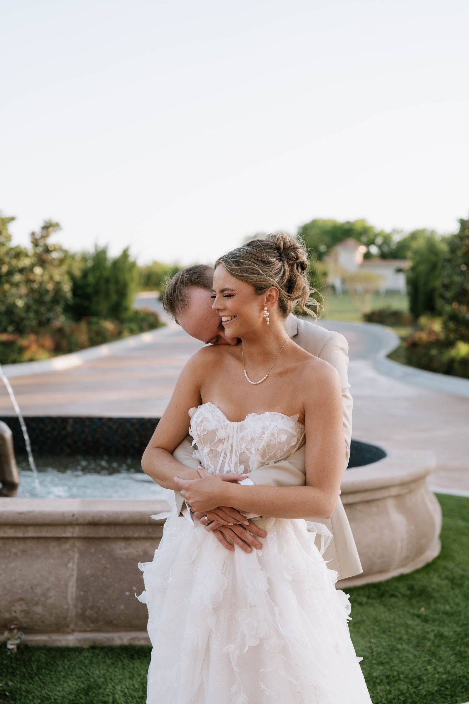 Romantic moment captured in an outdoor garden setting at sunset.