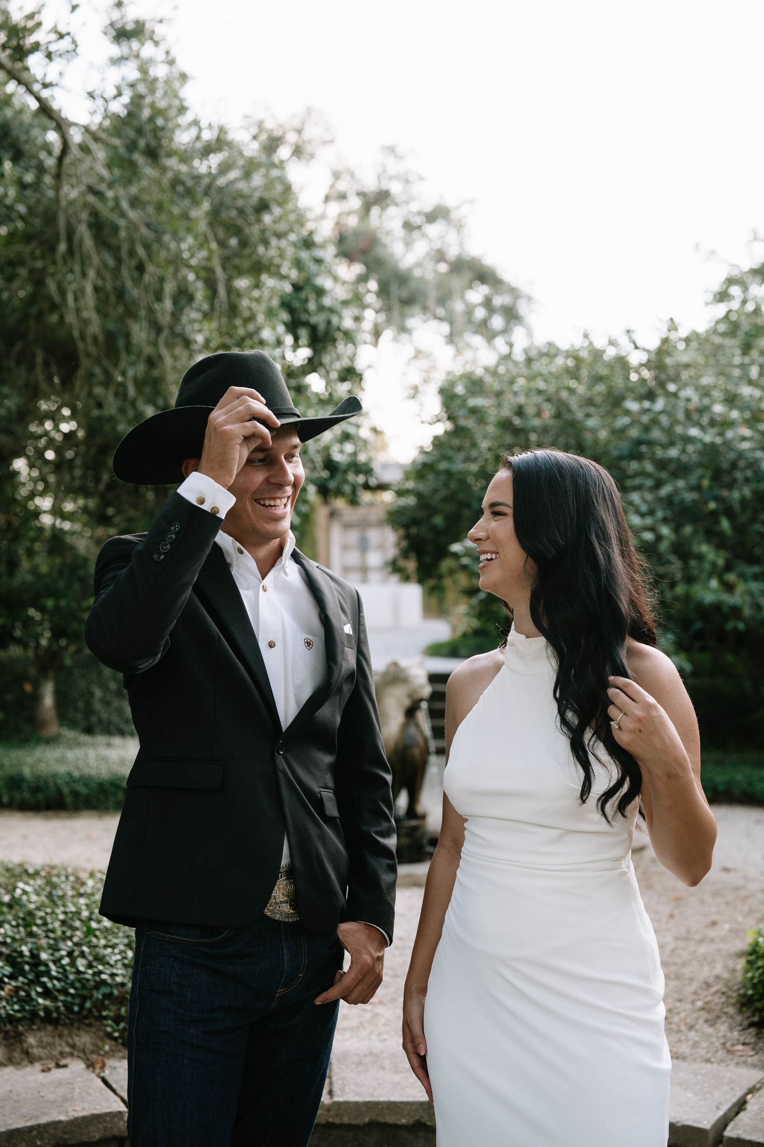 Candid moments between wedding couple sharing laughs outdoors. South Louisiana.