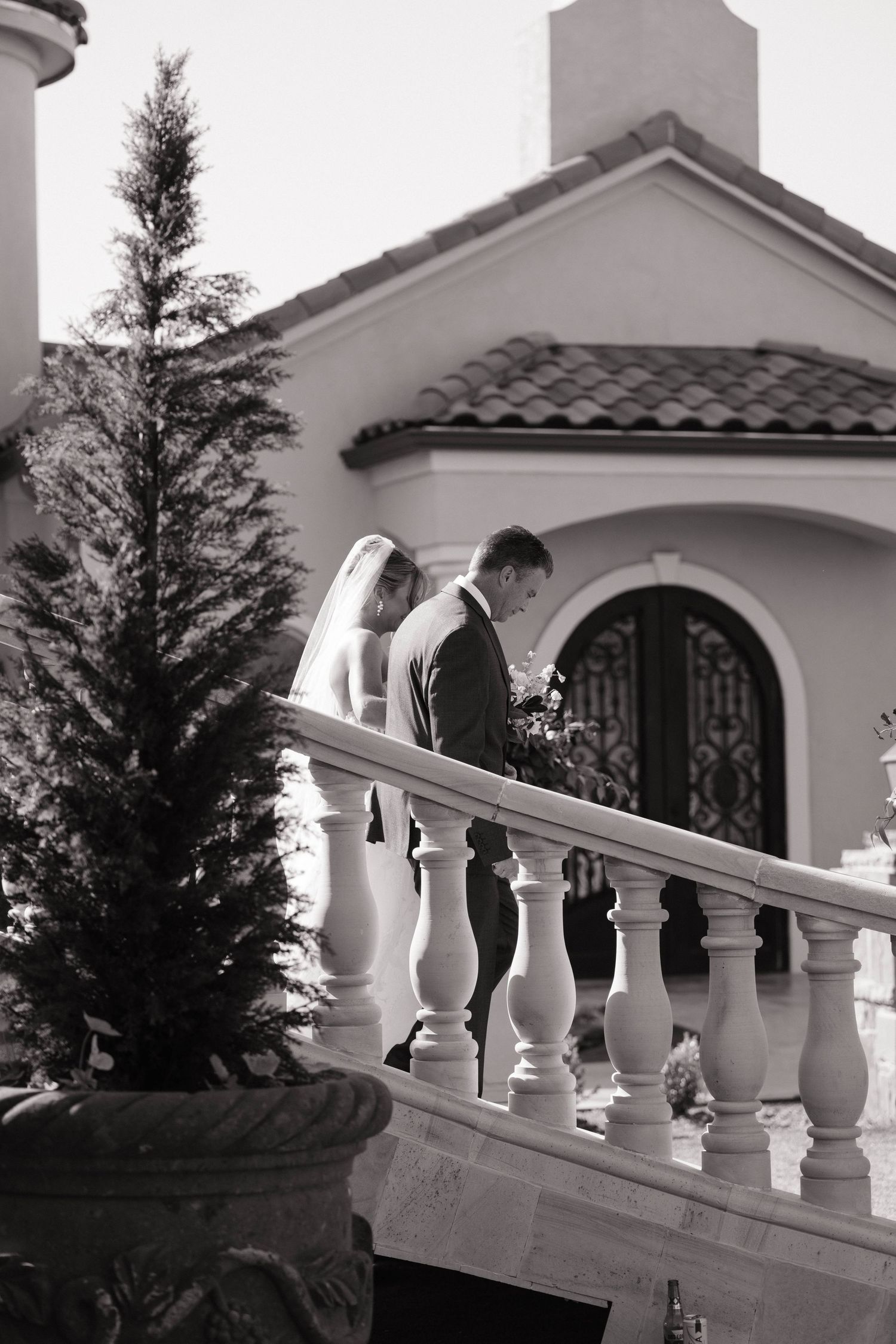Black and white architectural detail of Mediterranean style building with white balustrade.