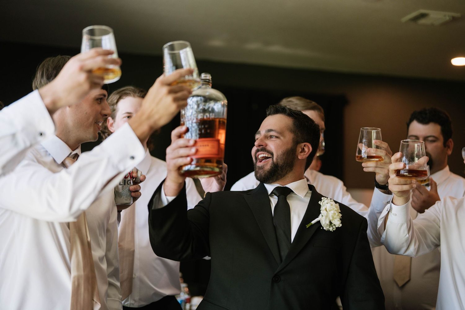 Wedding party toasting with champagne glasses during celebration.