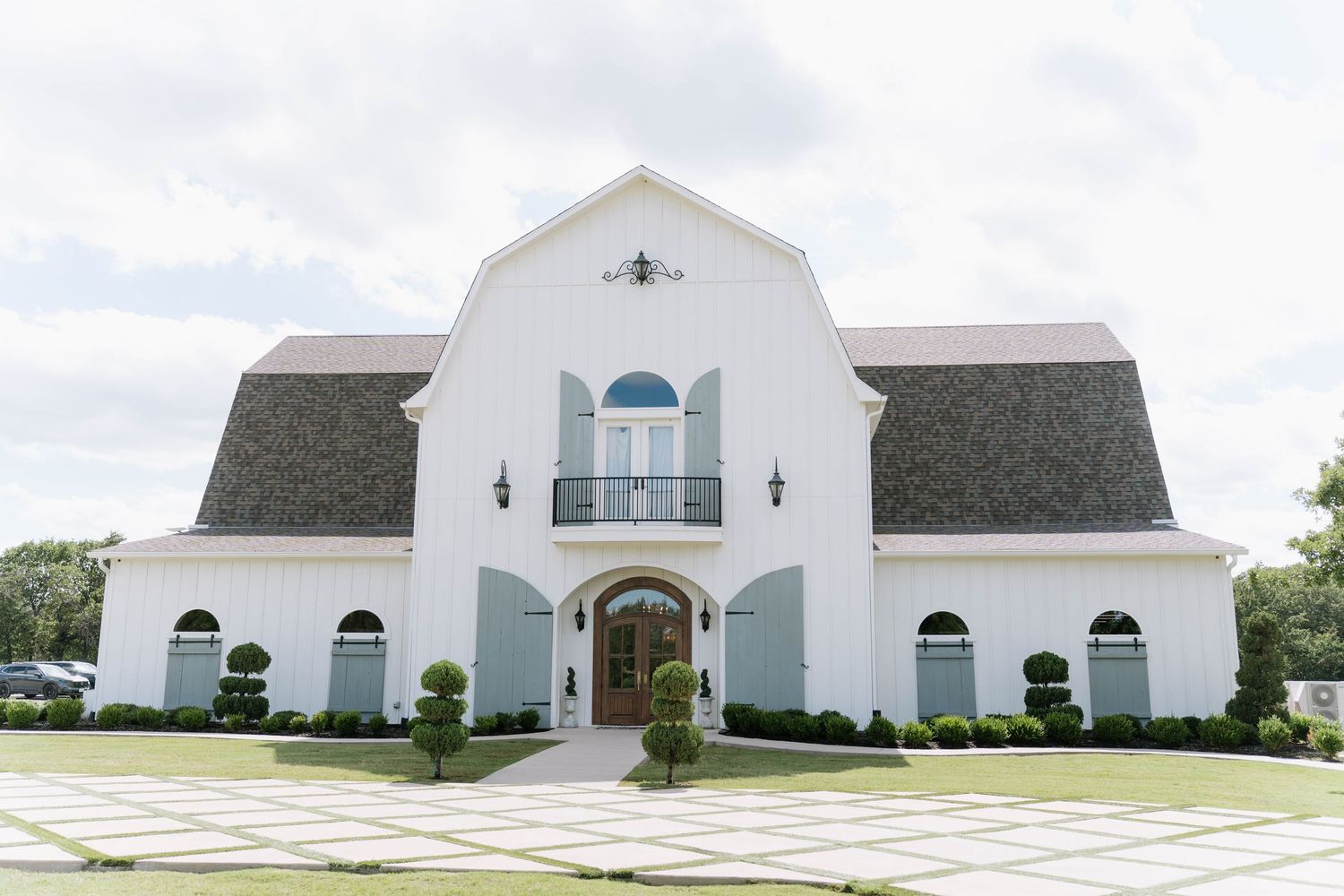 Exterior view of a white modern church building with arched architectural details.