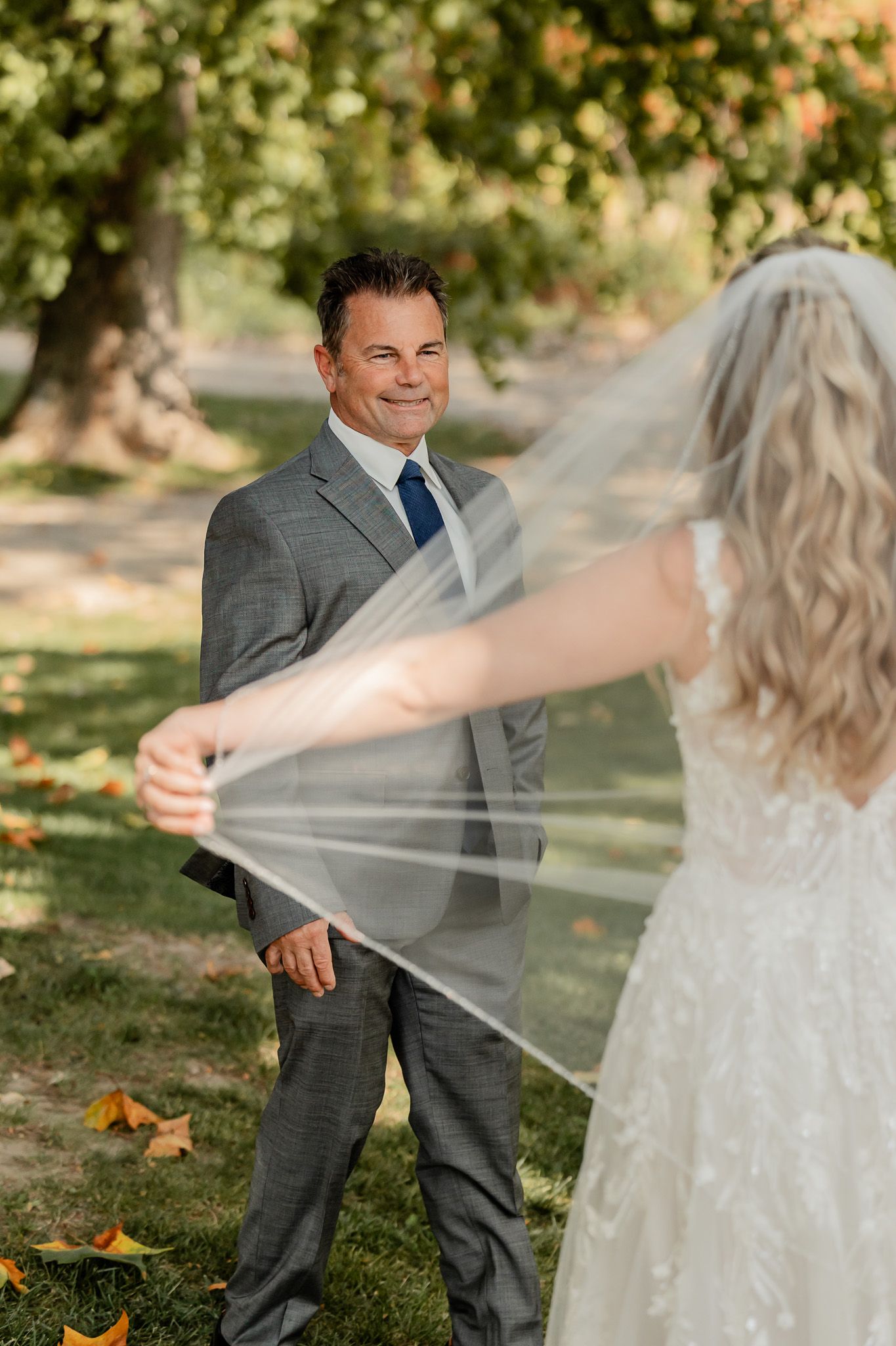 A tender first look moment between newlyweds in an autumn garden setting.