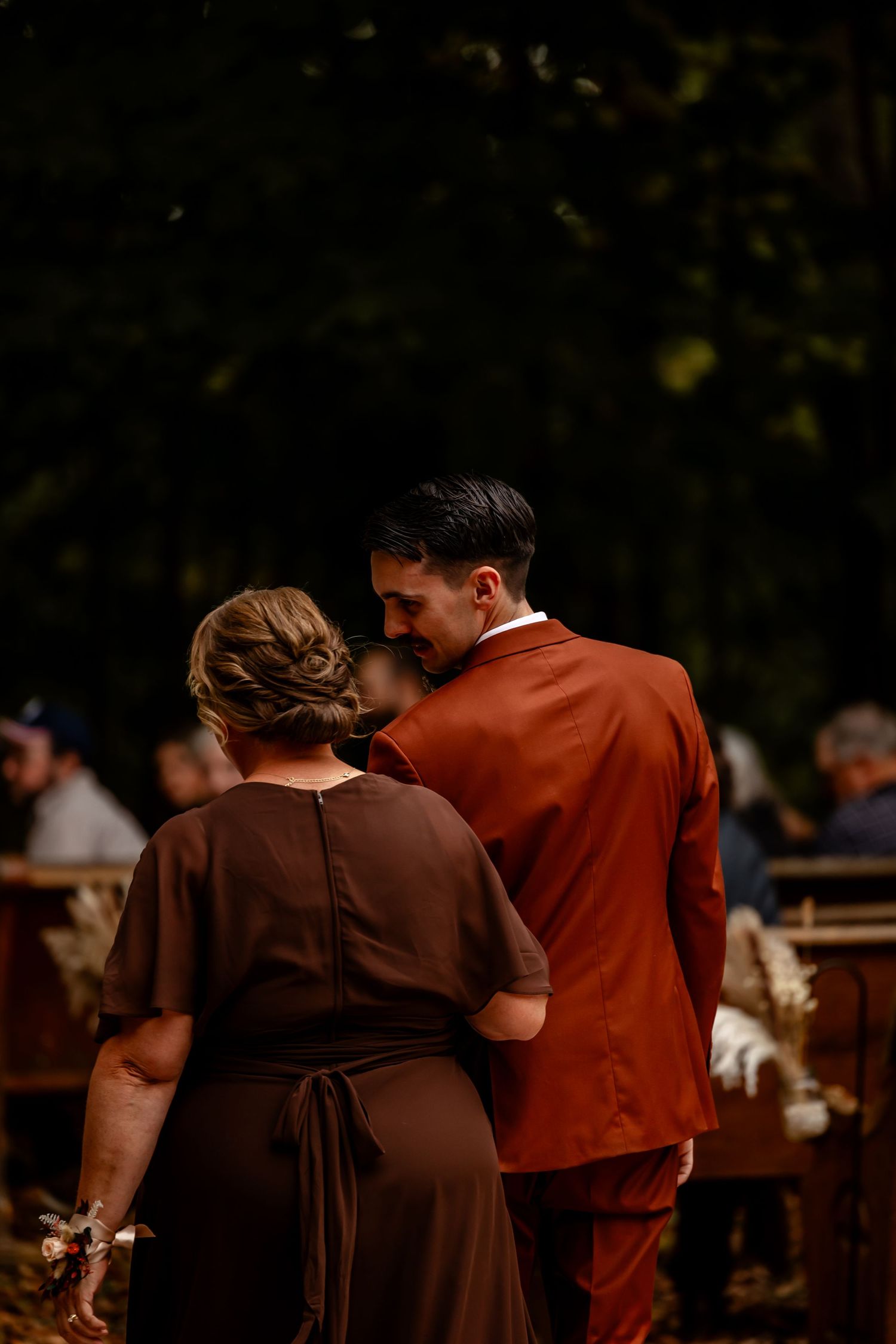 Guests mingling during an outdoor evening wedding reception.