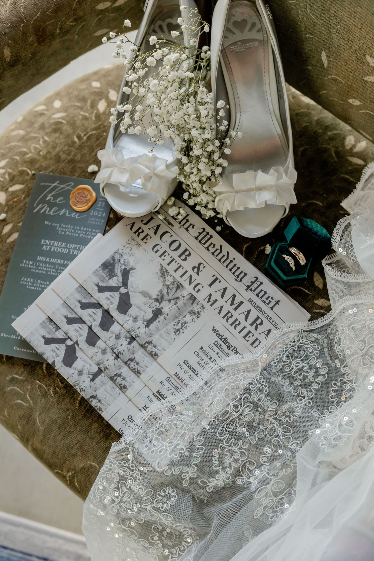 Wedding invitation suite with newspaper design layout and bridal accessories.