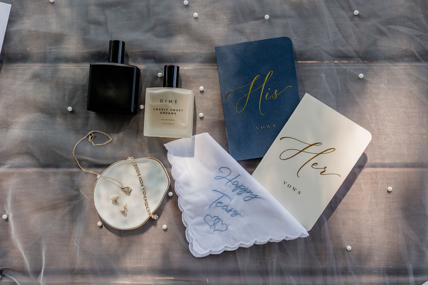 A collection of handmade wedding invitations and envelopes arranged in a rustic display on a wooden surface.