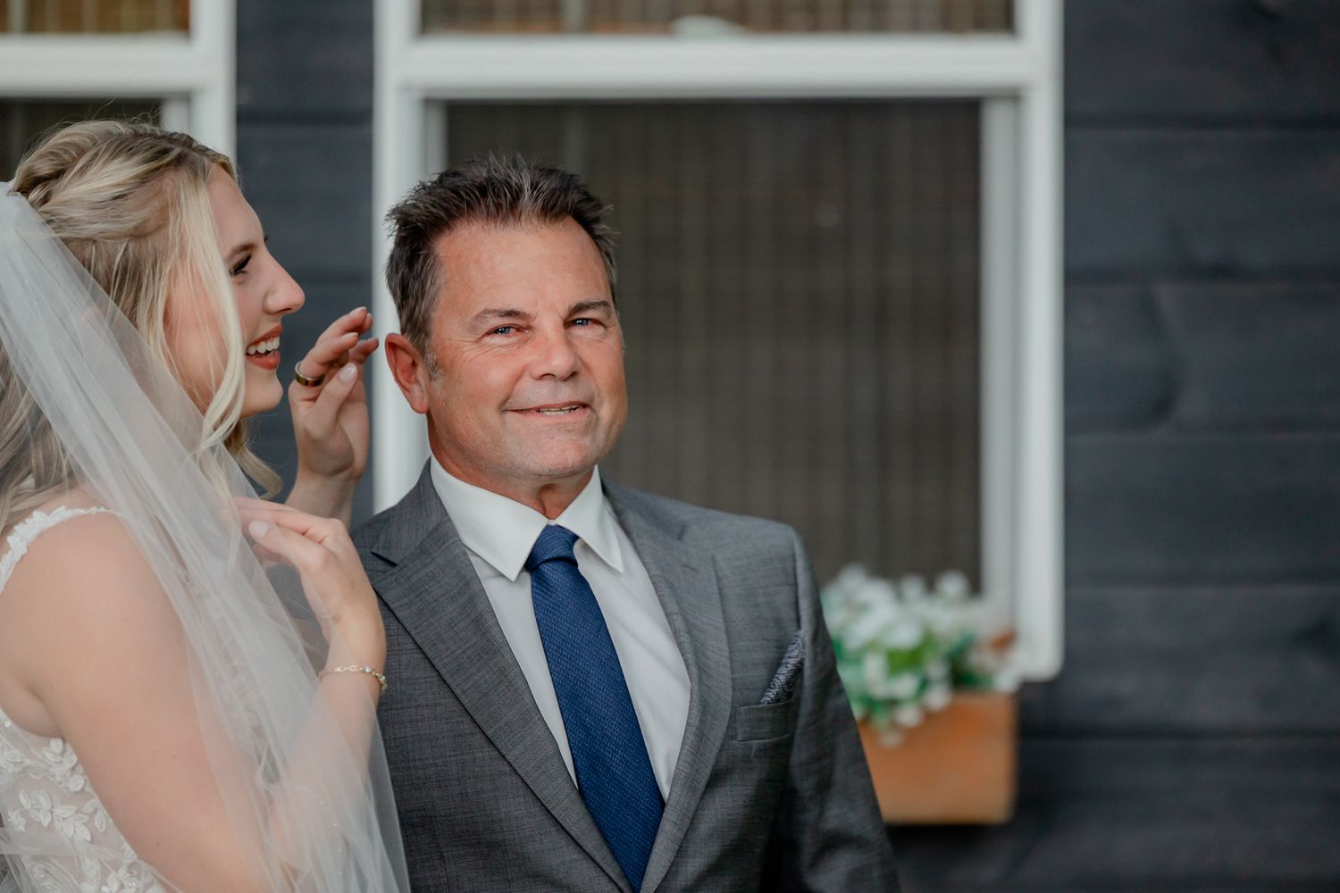A bride and groom share an intimate moment during their wedding ceremony in a rustic venue.