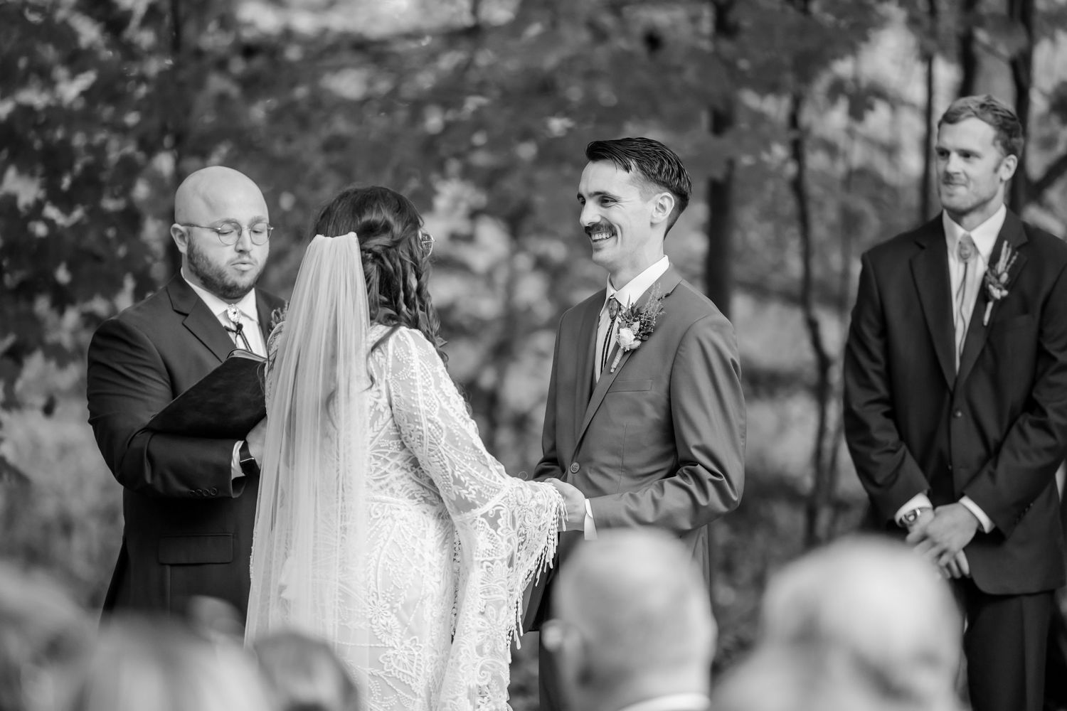 Black and white candid shots of wedding guests during an outdoor celebration. Wayland MI