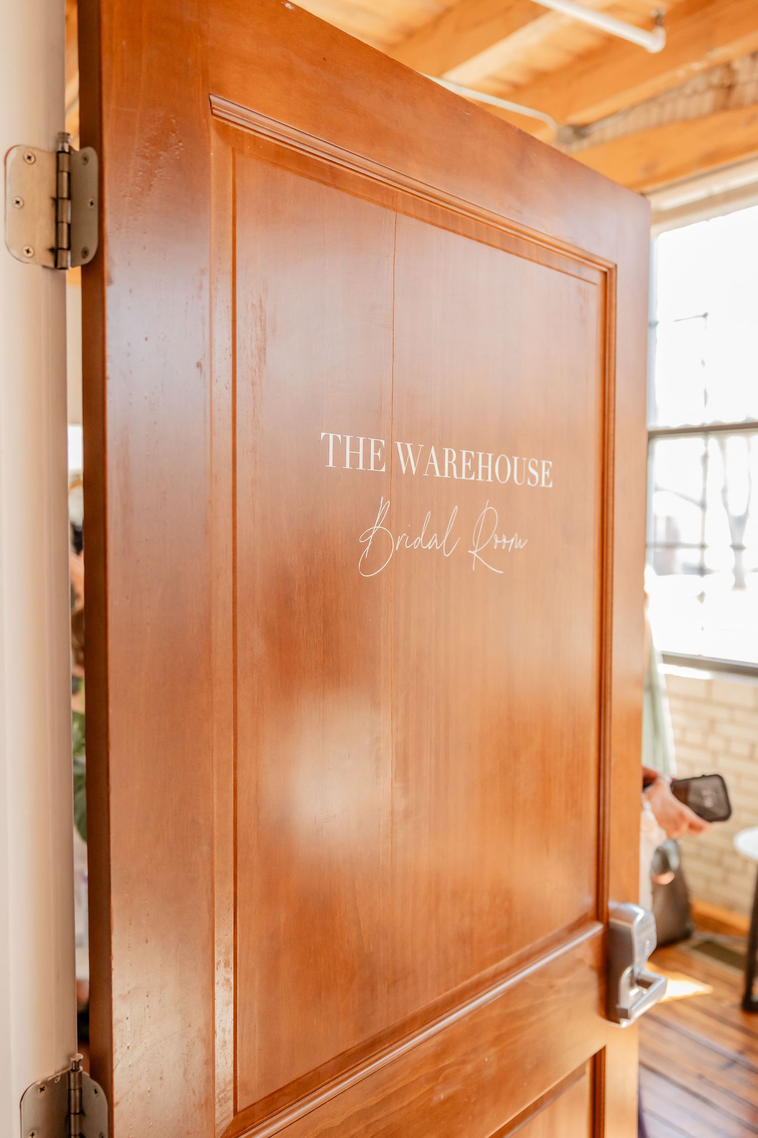 Wooden doors labeled 'The Warehouse' in elegant script lettering.
