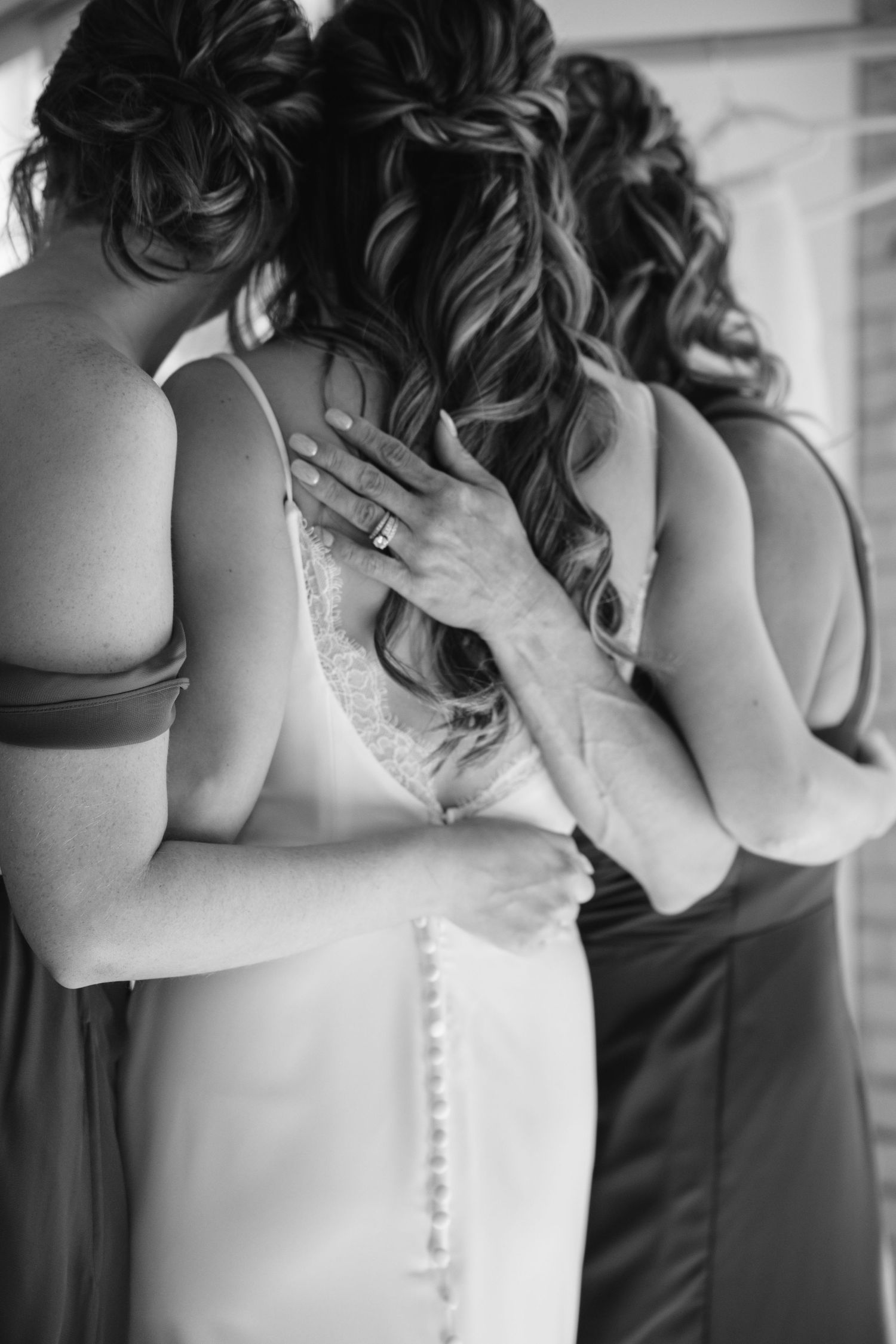 Black and white photo series showing elegant details of a bride getting dressed in her wedding gown.