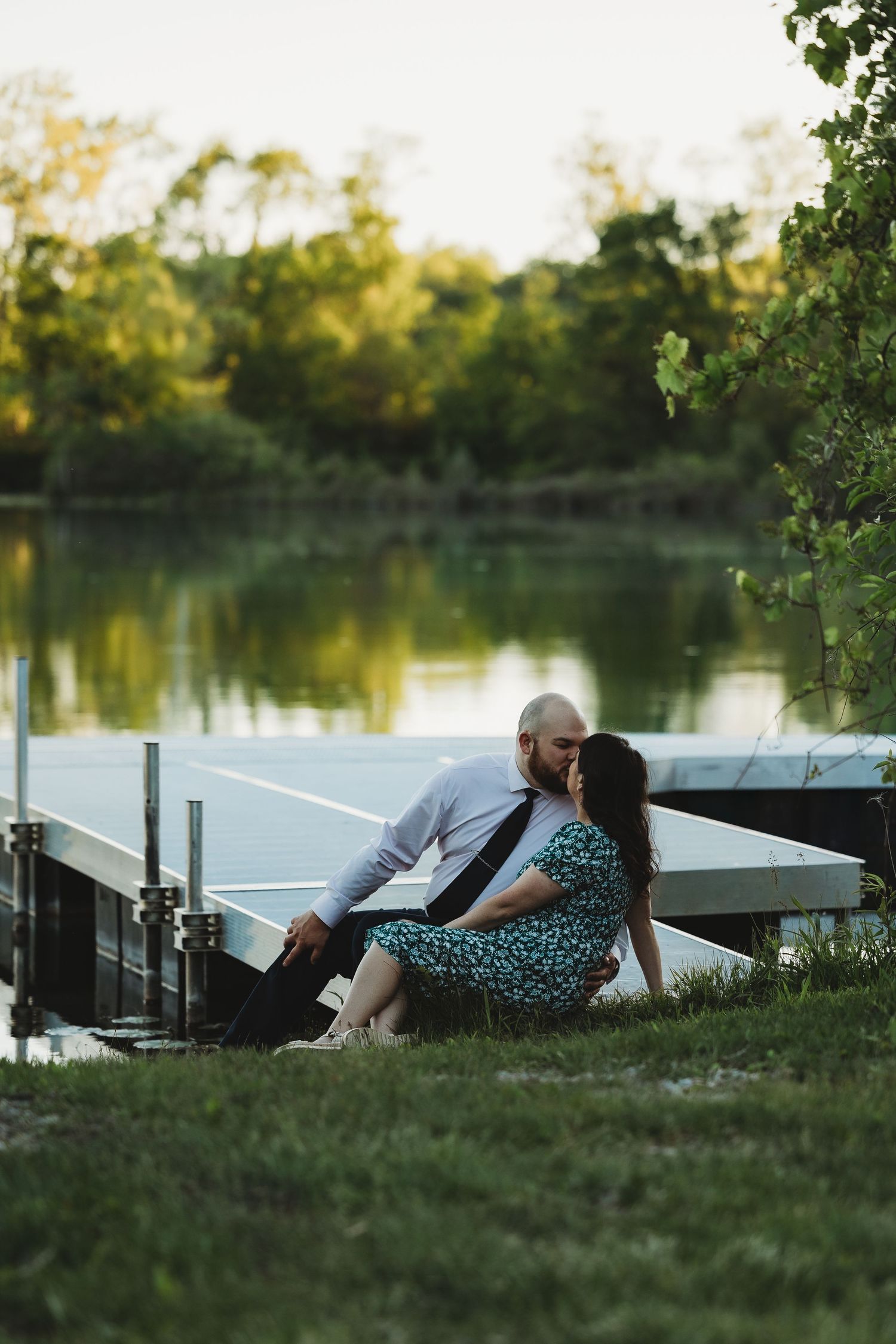 Couple relaxes on a lakeside dock during a peaceful sunset, Dowagiac