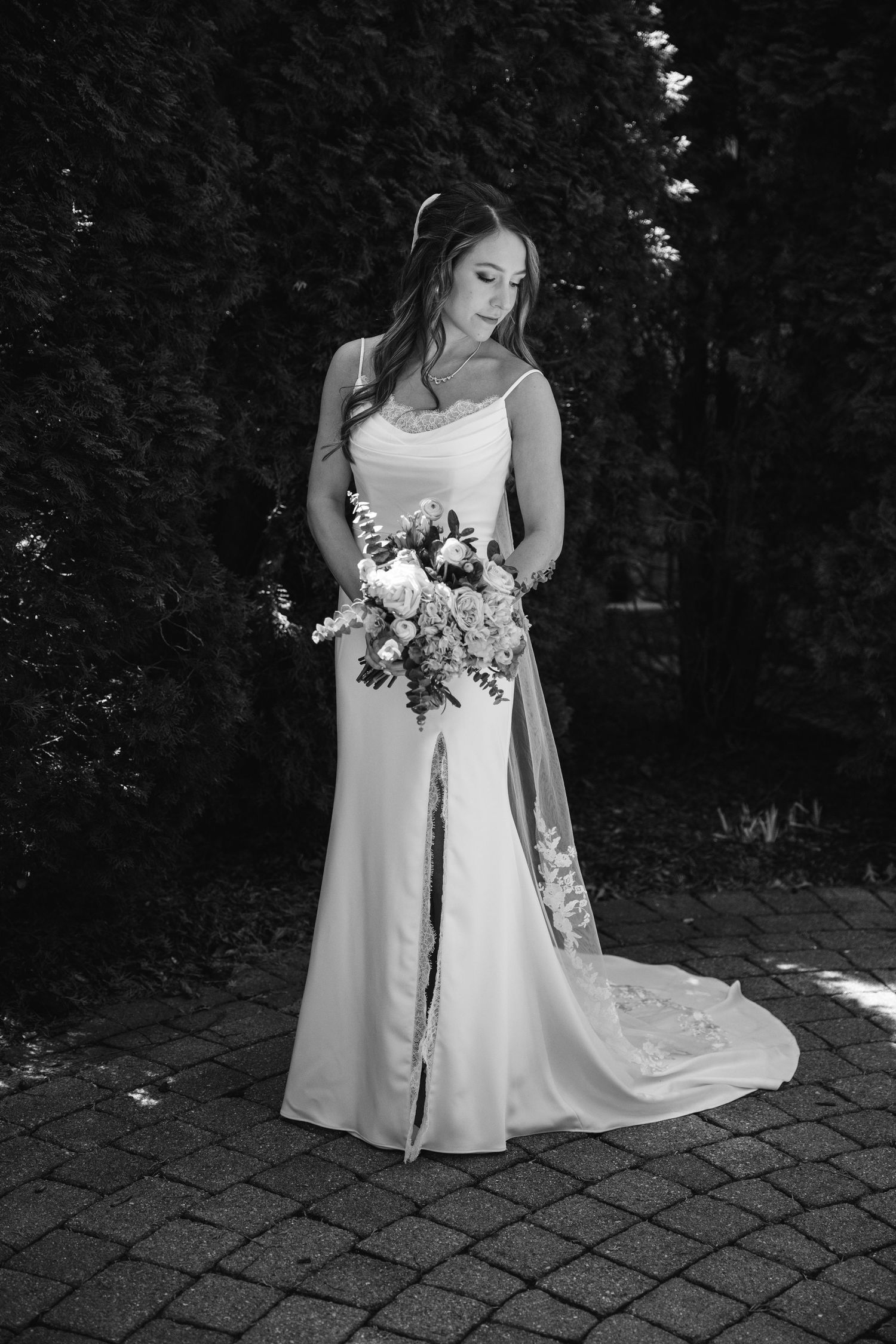 Black and white portraits of a bride in an elegant white wedding gown holding a bouquet.