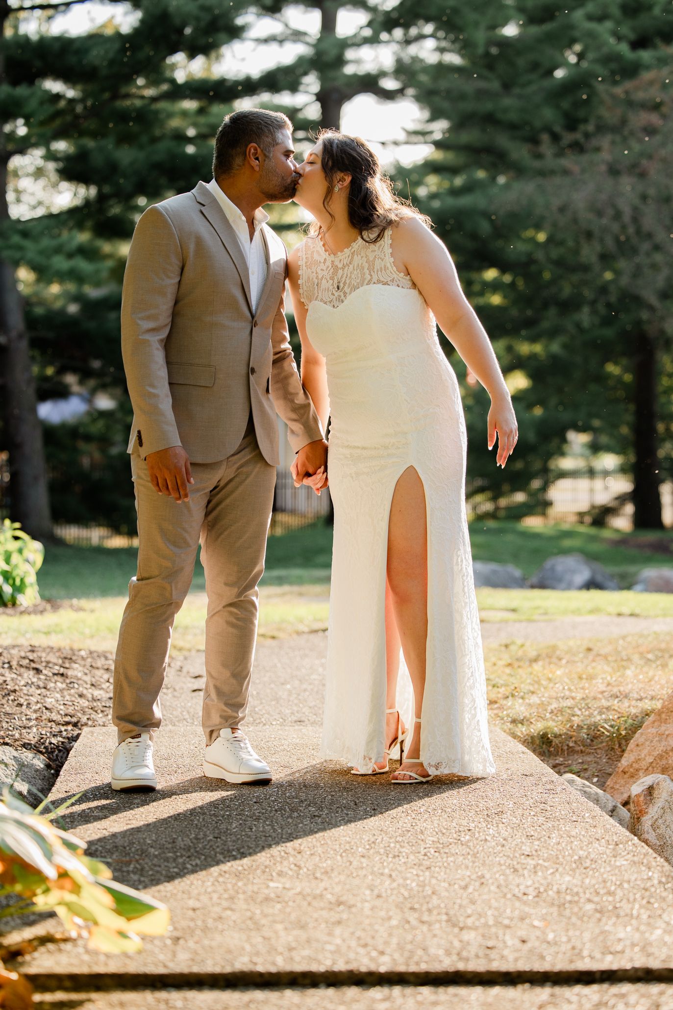 Three cropped photos showing the feet of a couple in wedding attire walking together on a path.