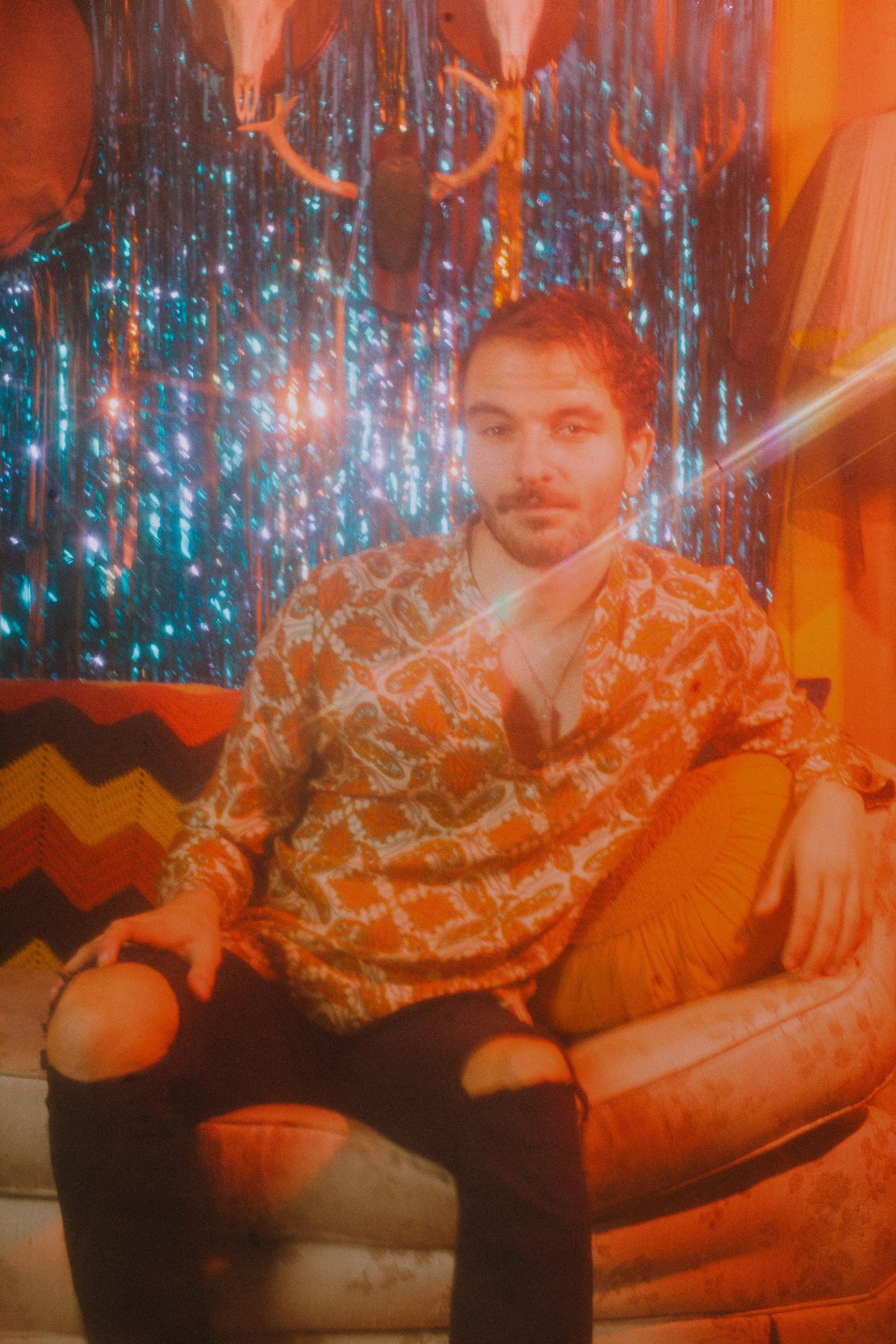 Artistic photo with orange lighting and blue sparkles creating a dreamy atmosphere.