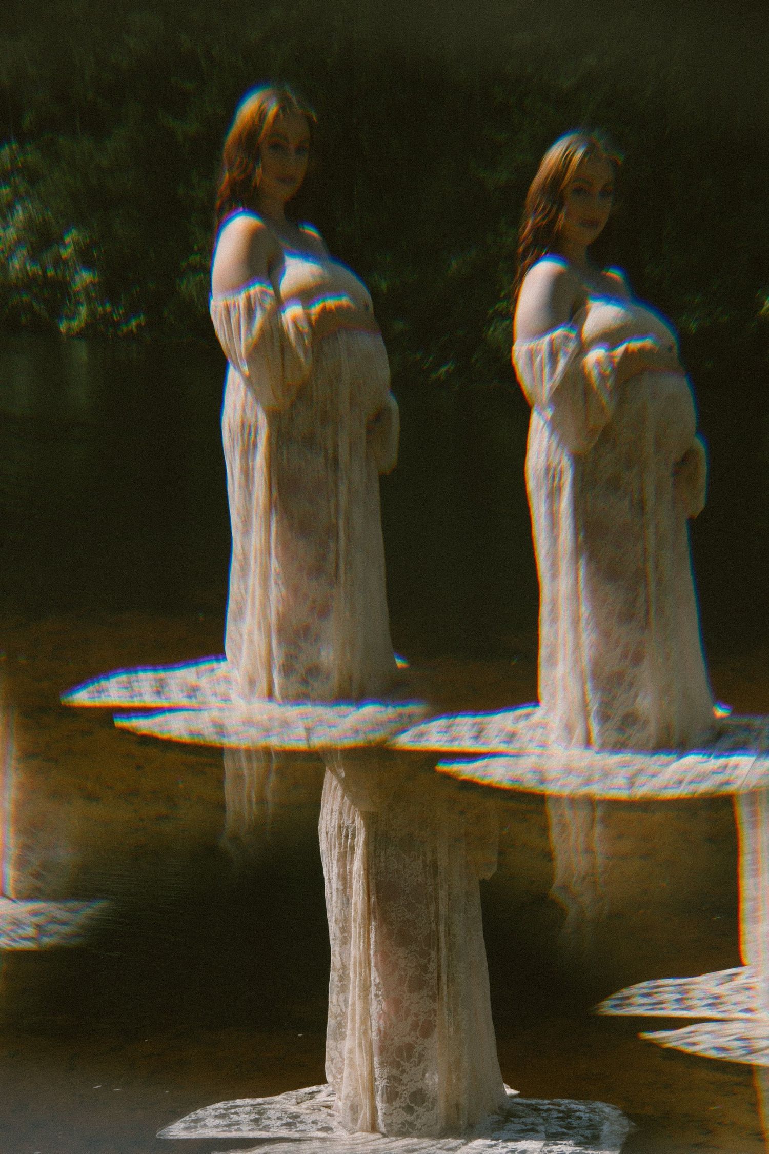 Artistic double exposure portrait of person in white dress creating ethereal effect.