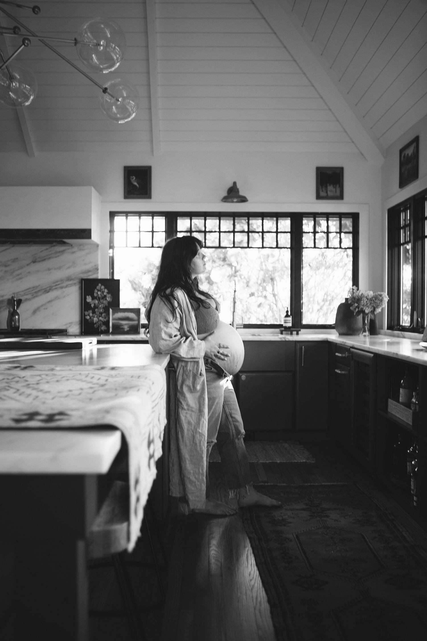 Black and white photo series showing a figure in white dress moving through a sunlit interior space.