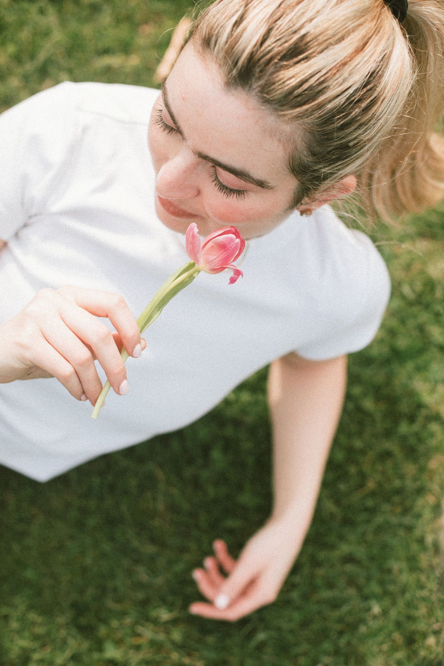 Playful sequence of someone blowing bubbles on green grass in summer.