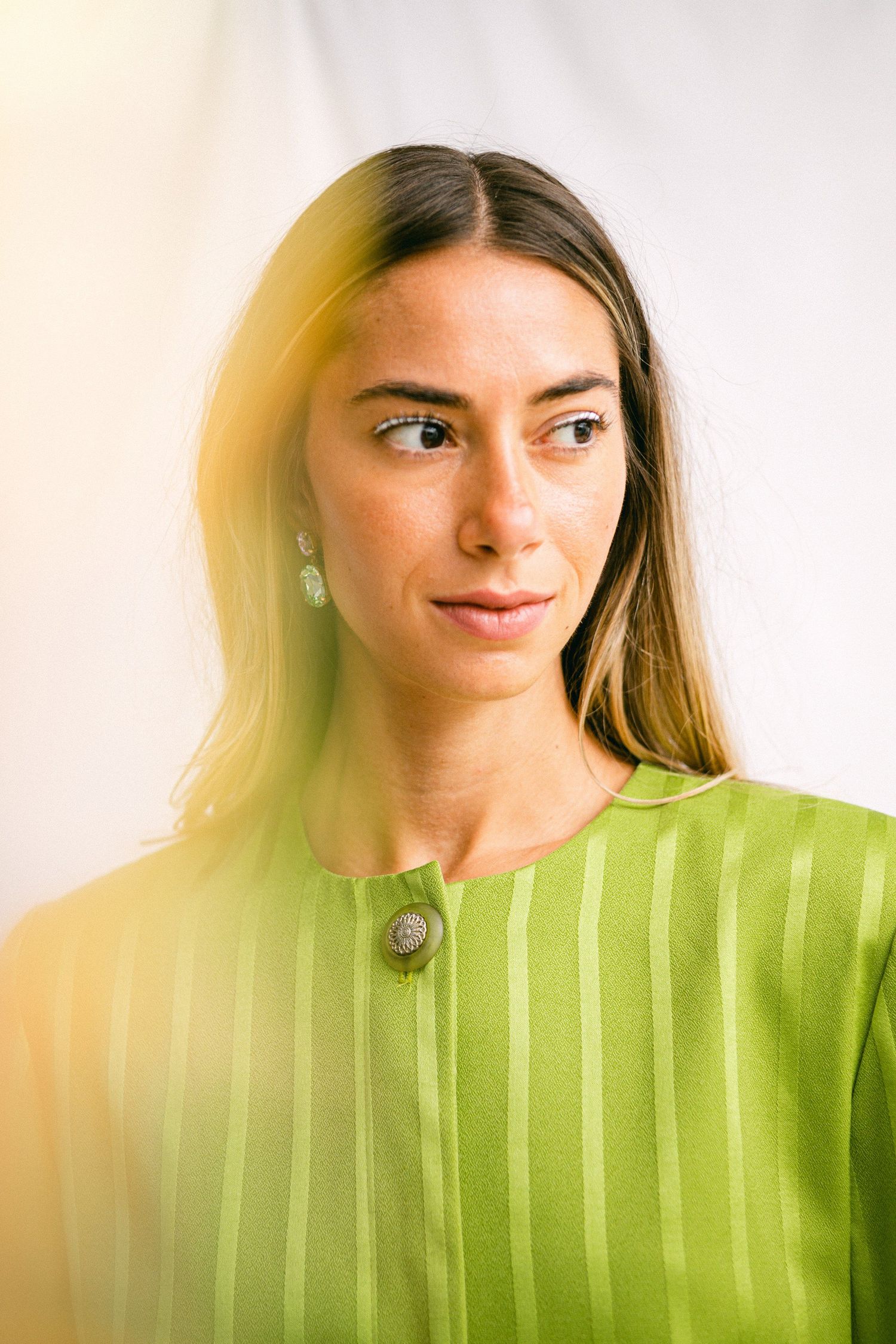 Portrait series in lime green striped clothing against white background.
