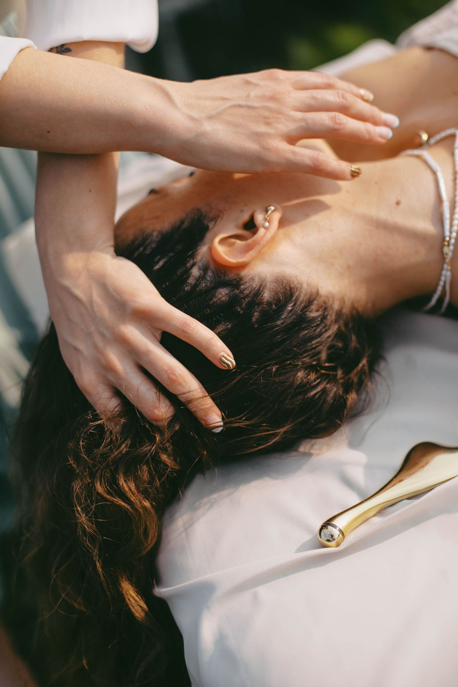 Close-up sequence of hands giving a relaxing head massage.