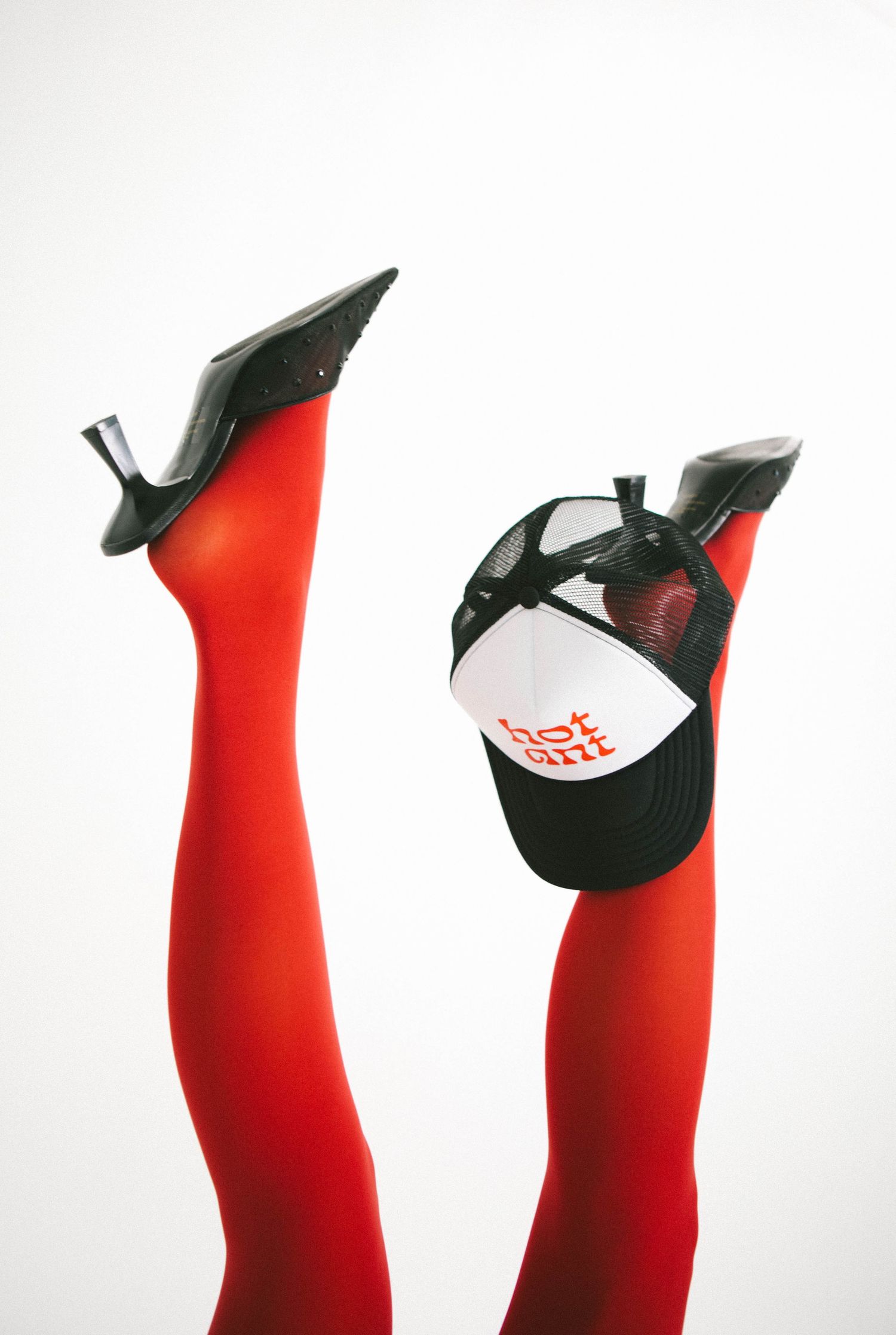 Red stockings with black and white branded caps in artistic composition.