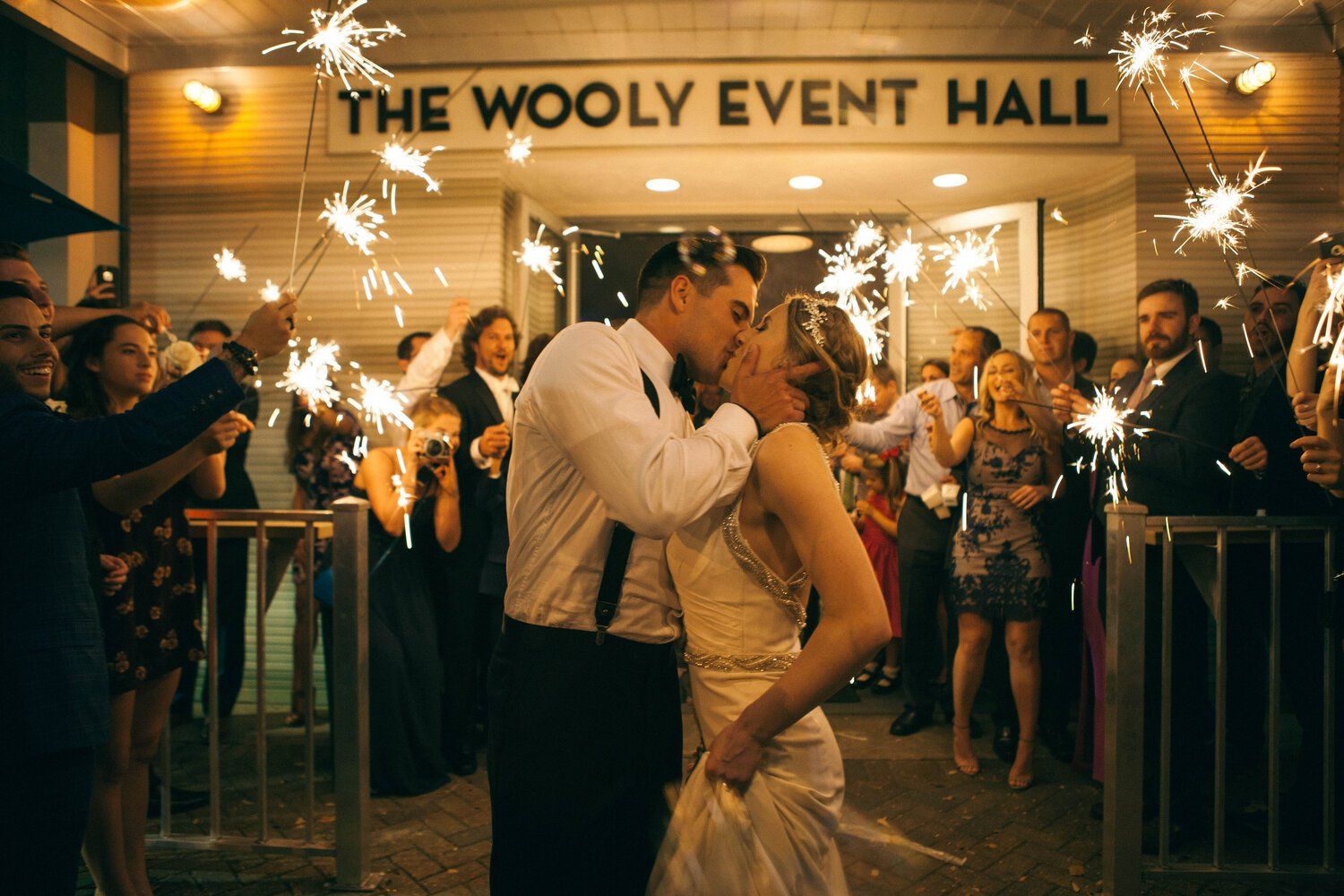 Sparklers illuminate the night at The Wooly Event Hall during a celebration.