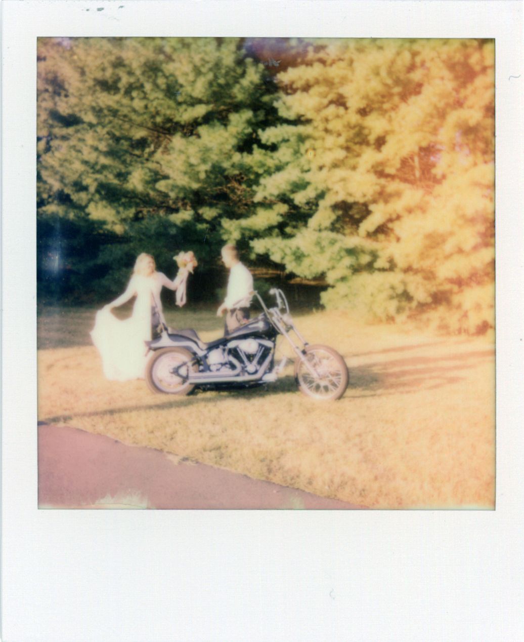 Vintage polaroid of motorcycle with wedding decorations in autumn setting.