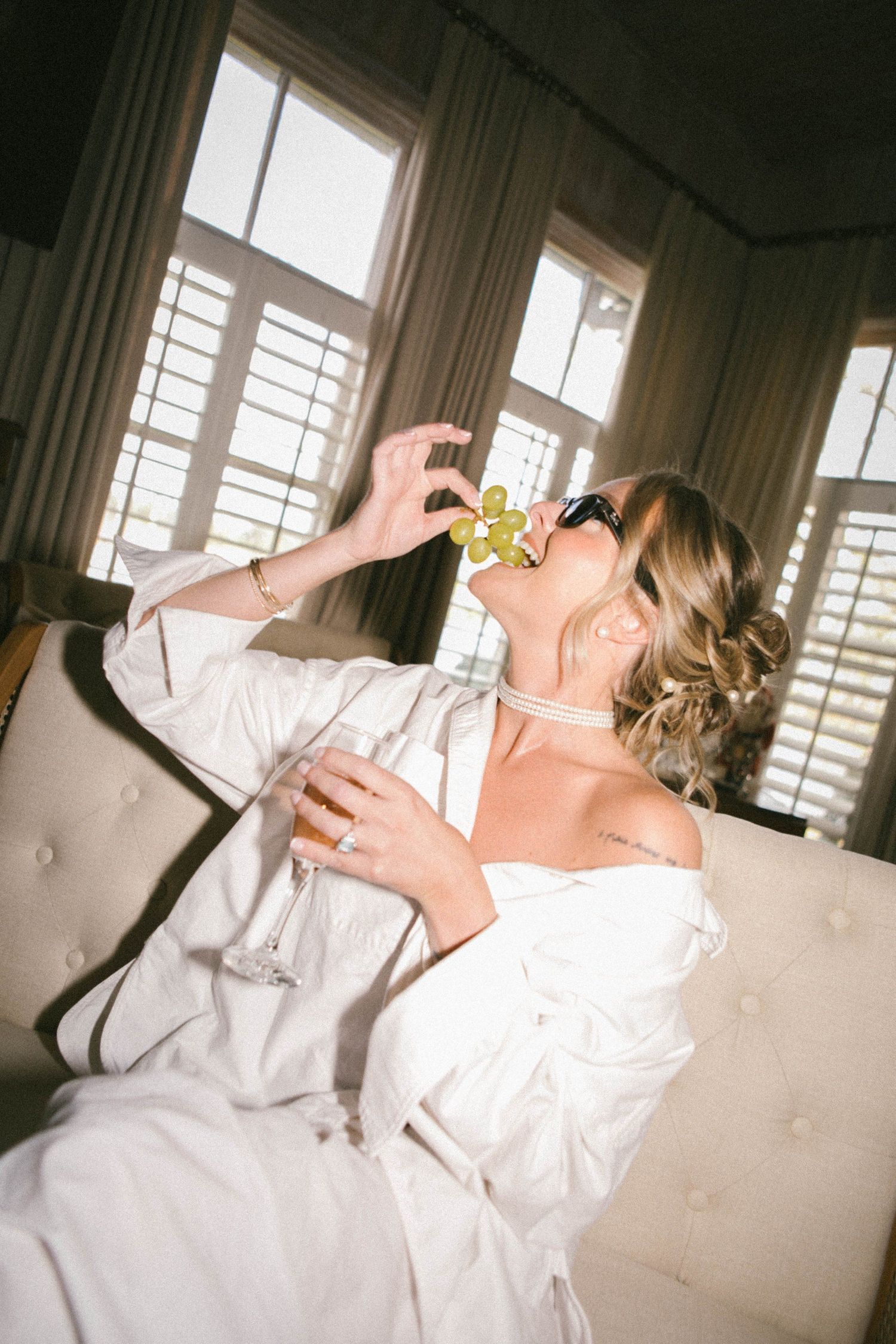Sequence of someone in a white dress reclining on furniture in a sunlit room.