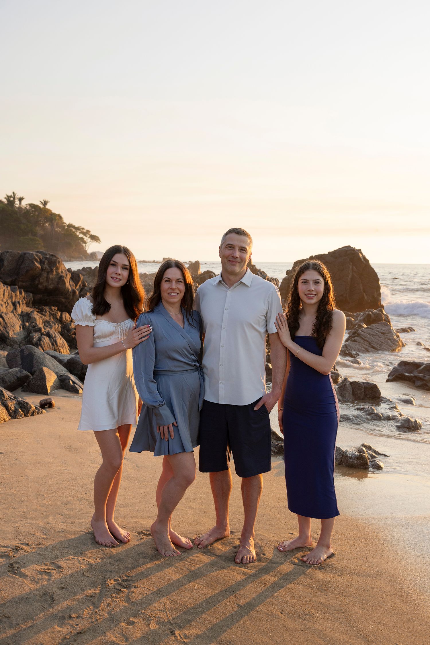 Sayulita family beach photo session capturing parents and daughters enjoying sunset portraits together.
