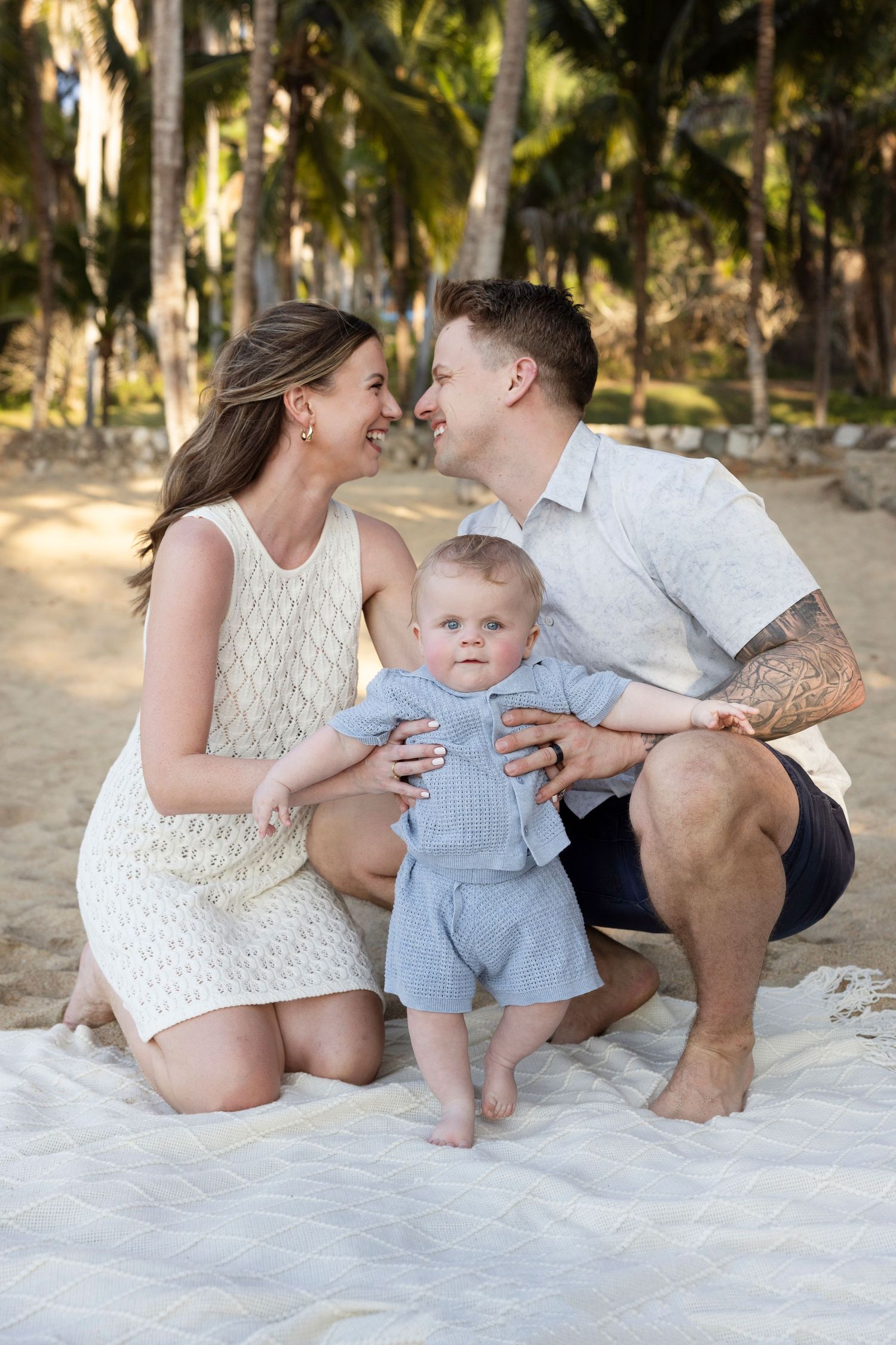 Sayulita family photographer capturing natural vacation portraits of parents and their young child in a tropical setting.