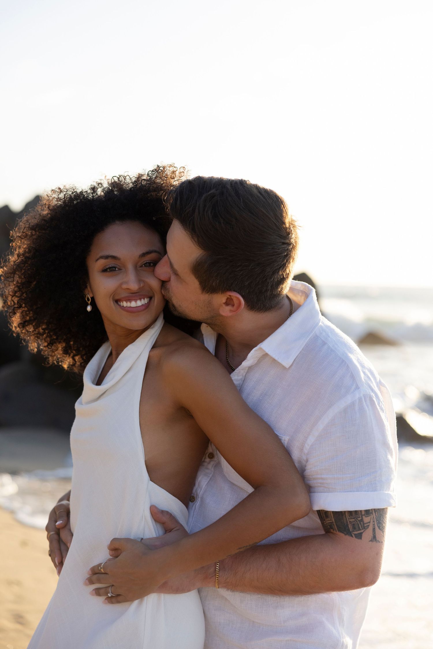 Sayulita couples photographer capturing romantic vacation portraits of a couple embracing on the beach.