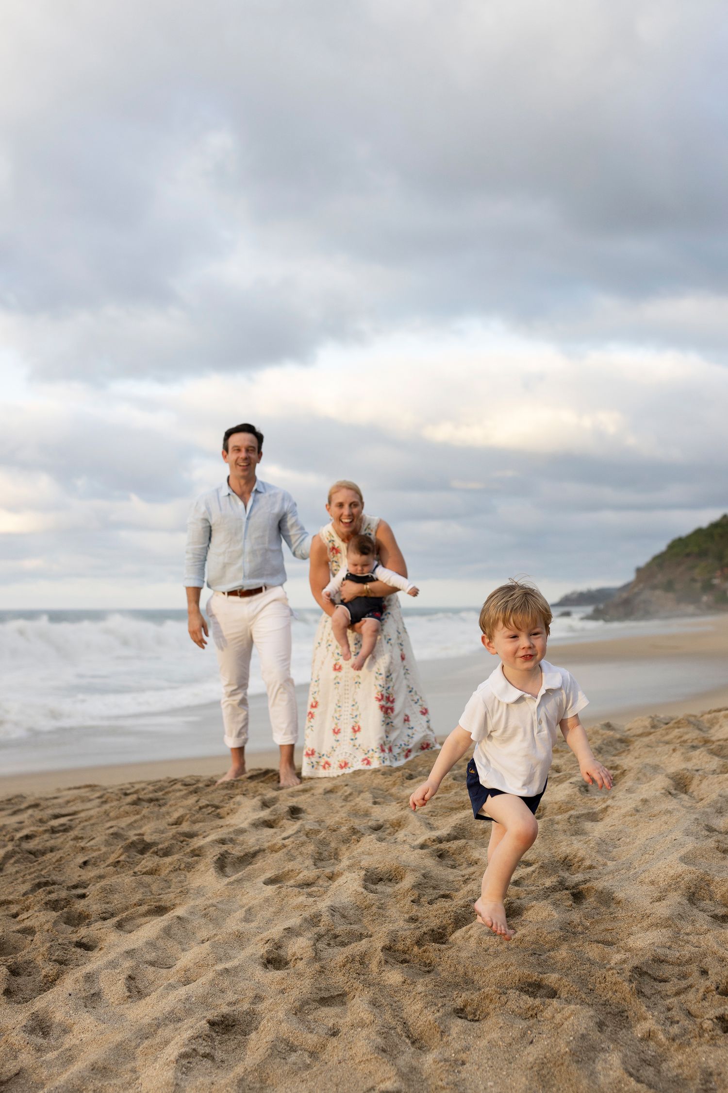 Family beach photography in Sayulita, Mexico, capturing candid vacation moments and natural portraits of parents and children.