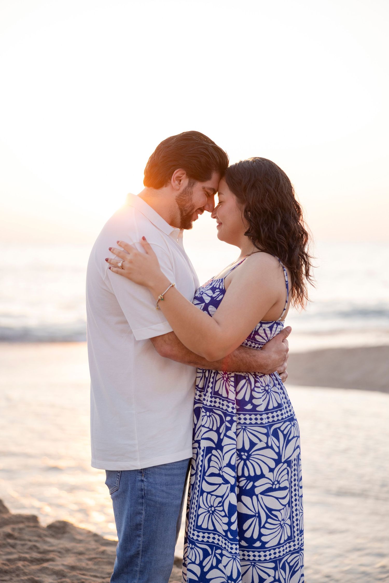 Romantic couples beach photography in Sayulita, Mexico, capturing an intimate embrace at sunset.