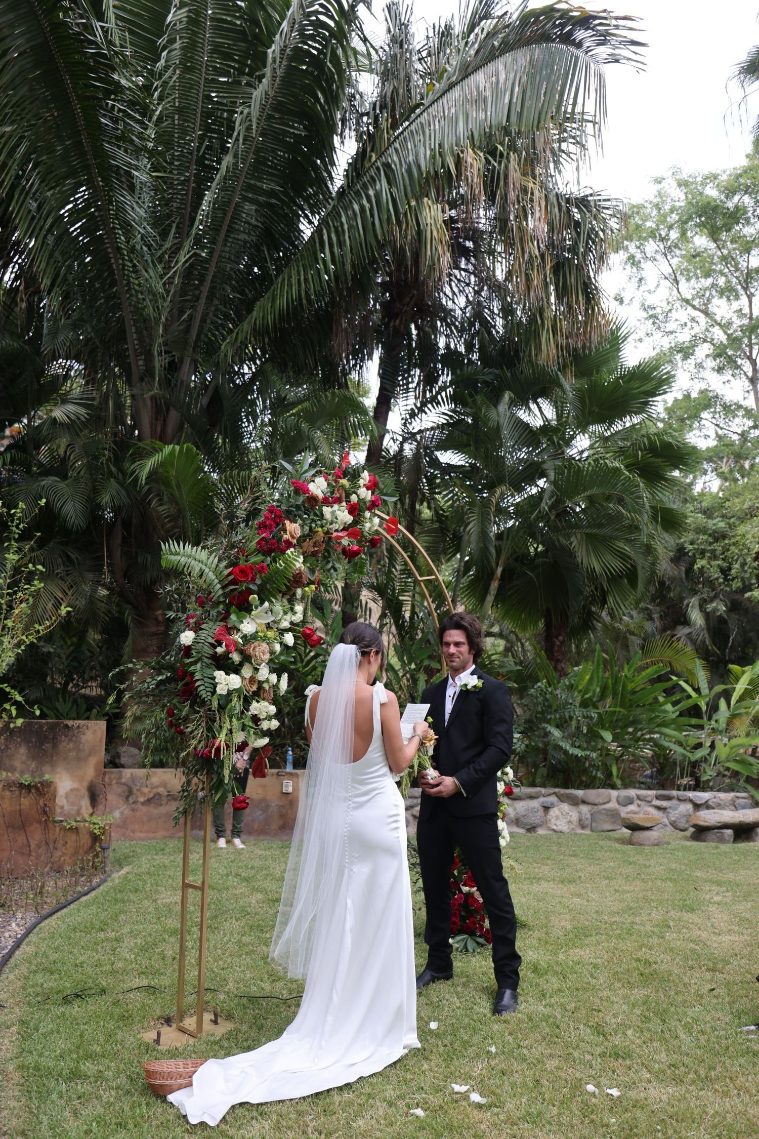 Destination wedding photography of a bride and groom in a tropical garden in Sayulita, Mexico.