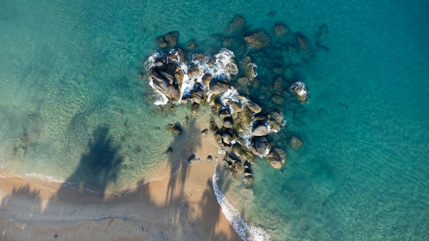 Aerial drone photography of a secluded beach and turquoise water in Sayulita, Mexico.