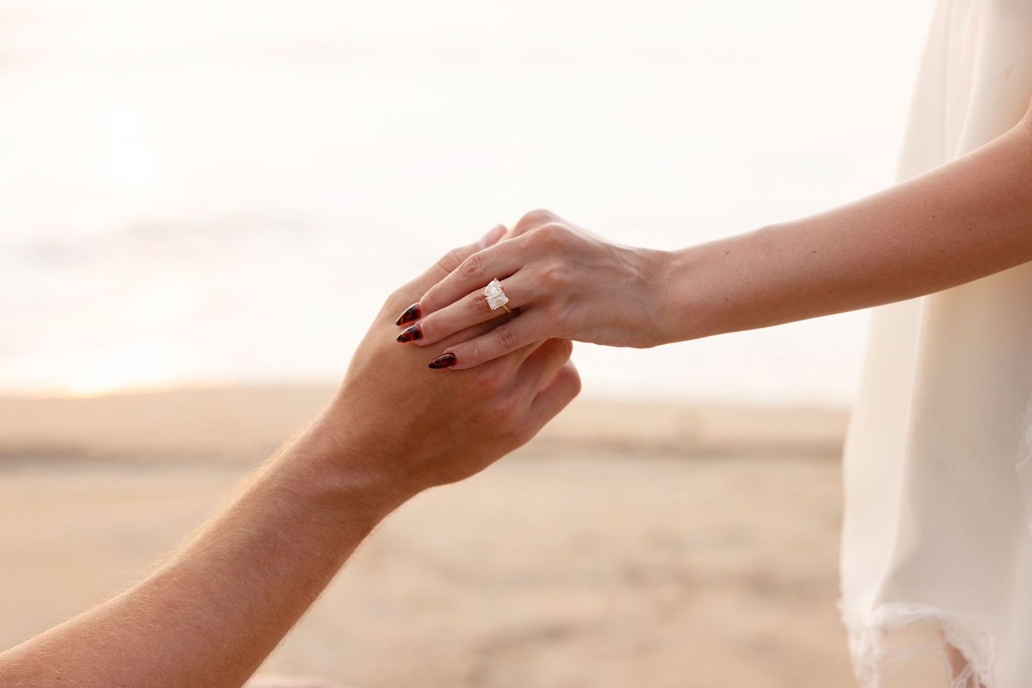 Surprise proposal photography on the beach in Sayulita, Mexico, capturing an intimate moment as a couple celebrates their engagement.